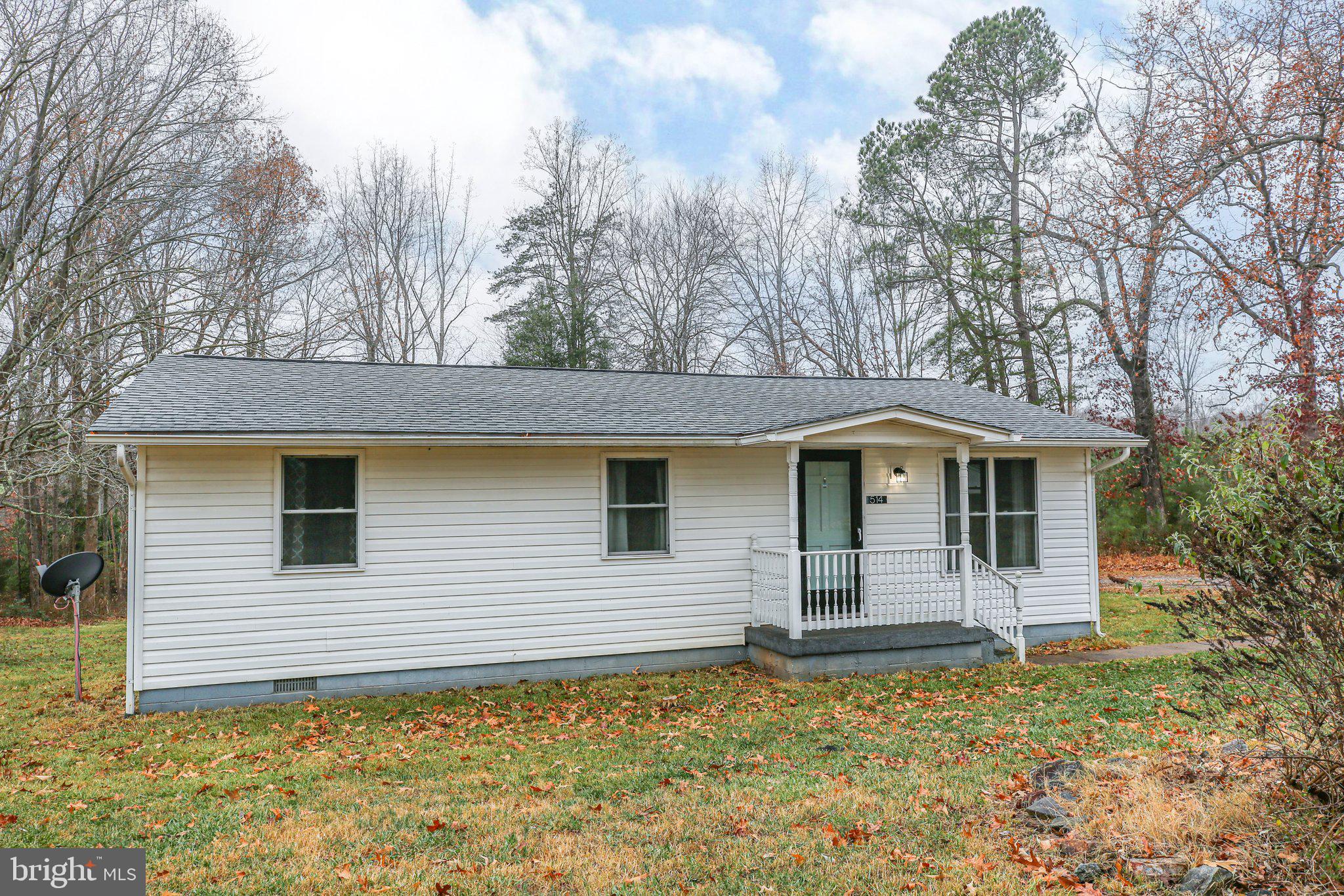 Upgrades aplenty within the last five-or-so years... single-level living... and a serene location!! Check all of the boxes at 514 Hancock Mill Road. This ranch-style abode has been under its current owners care since 2021. It includes three bedrooms, one full bath and more than 1,100 square feet of space. It sits on an 8/10-acre lot in Louisa County. It is approximately a five-minute drive from Mineral’s charming downtown, where select restaurants, shops and grocery selections await. Location-wise and worth noting, there is a high-end grocery store, urgent care and more under construction within a mile of the home! The western edge of Lake Anna is within a 10-minute drive, where endless outdoor and recreation opportunities abound. Multiple I-64 and I-95 exits are within 35 minutes. Zooming in on the acreage, a gravel driveway leads to the side of the residence, culminating in a three-walled shed. This could be stellar for storage, working on cars or... you name it! Out front, the grass is thick and full. There is a flower bed with a mature butterfly bush. On the side, you’ll find an expansive deck with direct access to the kitchen and dining room. Out back, you’ll find a rustic firepit and mature trees lining the property’s back side. The home itself is a stately white with a sea salt-colored front door. Worth noting, the roof was updated in 2018 as were the windows! Heading inside, you’ll find numerous cozy spaces as the original hardwood floors (recently refinished and gleaming!) and neutral colors radiate. Beyond the central living room are the dining room (with a double door to that side deck!) and the kitchen. The kitchen was updated in 2019 and includes natural wood cabinetry, white appliances, stone-esque laminate flooring, three big windows and single-door deck access. Off the living room is a hall that leads to the home’s three bedrooms and full bath. The full bath was retiled in 2018 and includes a subway tile draped tub/shower combo. All of the bedrooms are generally the same size and include hardwood flooring. One bedroom has a larger closet and will likely be perfect for your primary bedroom set-up. Systems- wise the hot water heater was updated in 2018 and a whole-house filtration system was installed in 2020. Prepare to be totally charmed by this Louisa County gem! If privacy, convenience and a single-level lifestyle are wants, prepare to get that and more at 514 Hancock Mill Road!