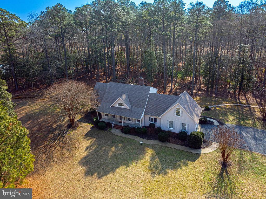 Price Adjustment! Discover the beauty of country living on this sprawling  20+ acre estate, ideal for fishing, hunting, and embracing the great outdoors while savoring the beauty of nature for you to embrace the vibrant life you truly deserve.  This beautiful 2 level home boasts three bedrooms, two and a half baths, and a versatile bonus room. Enjoy the spacious formal living and dining rooms, as well as a cozy great room featuring a Harmon pellet stove with a charming mantle surrounded by shiplap. The kitchen features modern appliances and stylish undermount lighting, while the kitchen bay window offers a picturesque view of the serene natural surroundings.  A delightful breakfast room opens up to a screened-in porch. ideal for relaxing evenings with your favorite beverage. The primary suite is conveniently located on the first floor and includes a luxurious jetted tub, dual vanities, and a newly updated stand-up shower with modern framing and doors. Additional property upgrades include contemporary lighting and ceiling fans on the second floor bedrooms, walk in attic, a tankless water heater, a water treatment system with both salt and chlorine options, reverse osmosis water filtration system and new outdoor lighting. Enjoy enhanced connectivity with a commercial cell phone booster and Starlink internet service. This home features an oversized two-car garage and a circular driveway, and flood insurance is not necessary. An existing security system is in place but not currently active. Conveniently situated just 10 minutes from Snow Hill and a short half-hour drive to the sandy shores of Ocean City, Maryland, this property offers the perfect blend of tranquility and accessibility. This property has everything you need and is competitively priced for a quick sale. Don’t miss out—call now for your private tour!
