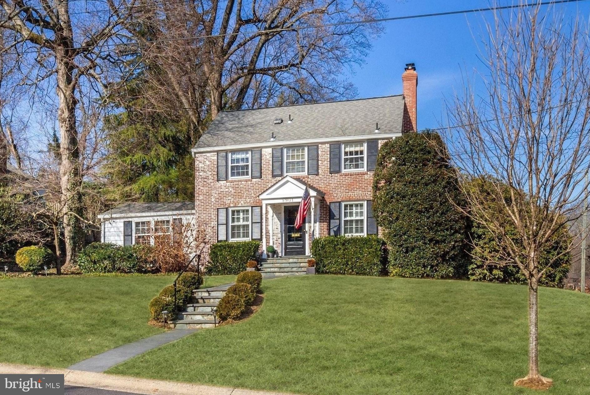 JUST LISTED in Woodacres! Open Houses Saturday (2/26) and Sunday (2/27) from 1-4pm.  Offers due Tuesday (March 1) at 12:00pm. 
This handsome 1955 brick colonial is full of charm and curb appeal, on a sunny southeast facing corner lot with mature landscaping. A front portico entry opens into the Main Level foyer with hardwood floors that flow throughout the Living Room with fireplace, Family Room with cathedral ceiling, stainless steel Kitchen, formal Dining Room, Powder Room, and Den / Home Office. A sliding glass door from the Family Room walks out to the spacious rear deck and garden. The Second Level offers 3 Bedrooms and 2 Full Bathrooms upstairs, including the Master Bedroom with en suite. The Lower Level includes a Recreation Room, second Powder Room, Laundry and Storage Room, and direct access to the home's 1-Car Garage.