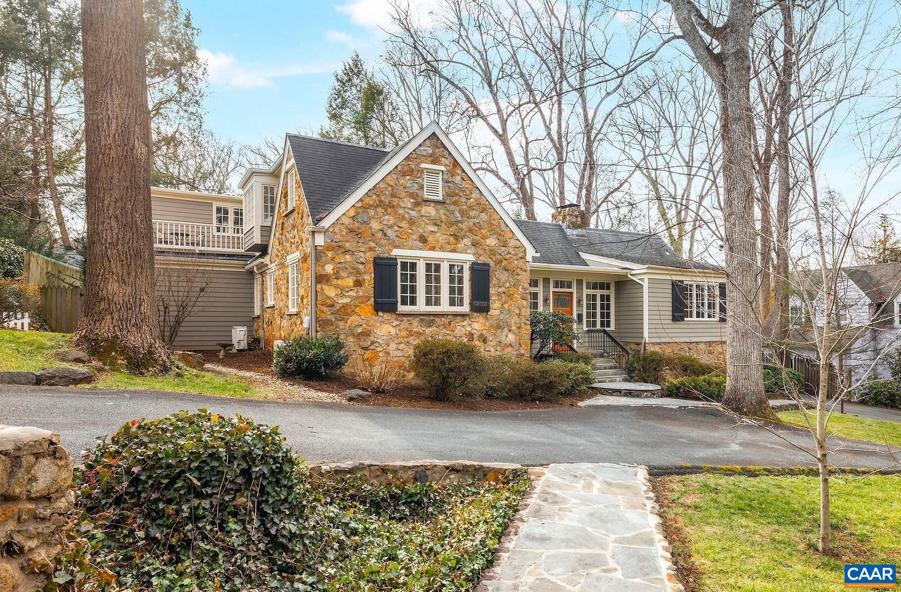 Set on a wide, tree-lined street within an easy mile walk to UVA?s campus, Law, Darden and Medical Schools, JPJ, and the Performing Arts Center, this timeless 1935 stone residence is rich with charm featuring beautiful trim work, inviting nooks and crannies, large deep-set windows with generous sills and French doors that fill the interiors with natural light. A bluestone-floored foyer opens to a spacious great room with a wood-burning fireplace and French doors leading to exceptional outdoor living spaces, including a bluestone terrace with built-in seating, a large deck and mature plantings of hydrangeas, roses and dogwoods, creating a private, serene setting for entertaining. The flexible floor plan offers comfortable one-level living with a first-floor primary suite featuring a wood-burning fireplace and direct access to a private patio, outdoor shower and hot tub. Also on the main level are a cozy den with extensive built-ins, an office or fifth bedroom with full bath and a charming kitchen with breakfast nook and dining room overlooking the front yard and adjacent open green space. Additional features include 3 bedrooms with private baths, an expansive cedar-lined storage room and a stone-walled mudroom and workshop.,Painted Cabinets,Wood Cabinets,Fireplace in Great Room,Fireplace in Master Bedroom