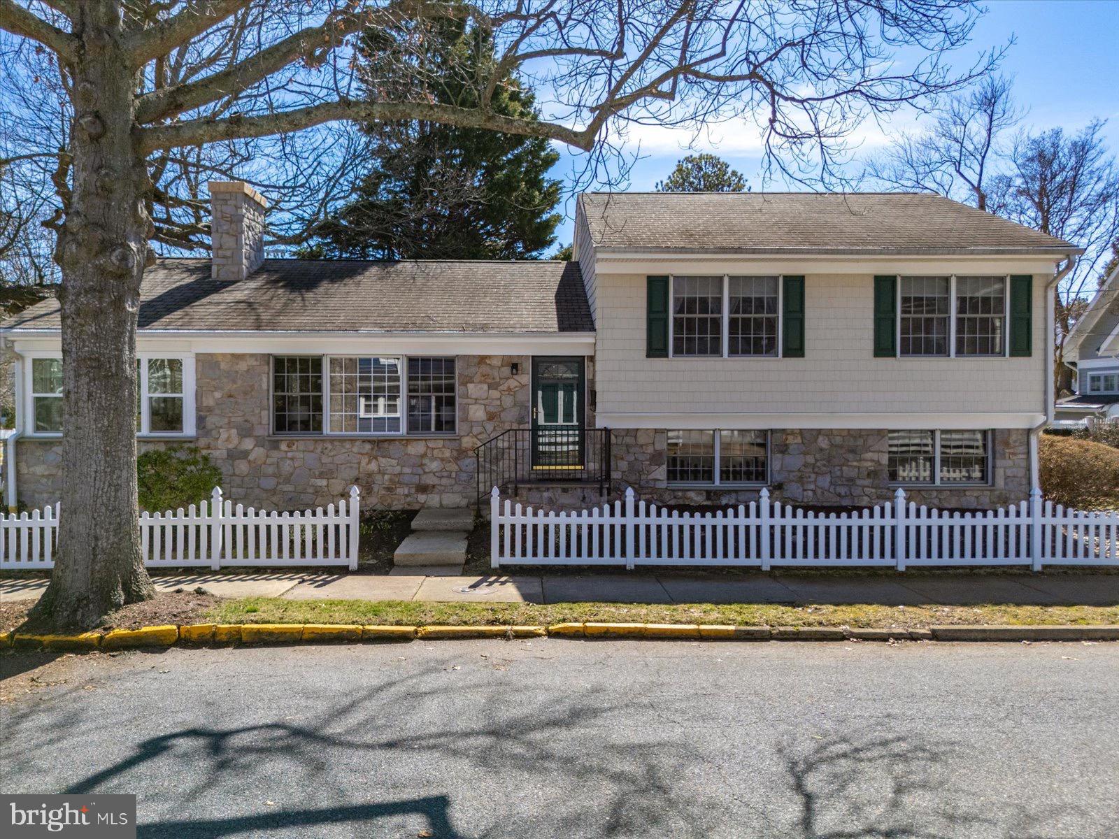If your dream is to own a stone front beach home with a white picket fence, just blocks from the sea - this home is your dream come true! This mid-century gem is positioned in downtown south Rehoboth Beach, on a sunny corner lot.  The property is just two blocks from the Boardwalk and Ocean Beaches and three blocks to picturesque Silver Lake.  This charming family home has the ideal location for shopping, dining, playing in the sand, or lazy strolls through the quintessential beach town to soak up coastal vibes!  Whether for beach weekend getaways, a primary residence, or investment opportunity, this home combines stellar convenience, coastal charm and nostalgia, from a by-gone era.  Nestled on the corner of Bayard Avenue and Stockley Street, 701 Bayard offers a spacious living area, a brick faced wood burning fireplace, bright east facing sunroom, an outdoor shower, walk out basement and brick patio.  With four bedrooms and a flexible floorpan the home lives well, offering two living areas, and a large sunroom which extends the width of the home along Bayard Avenue.  The open living/dining area is ideal for entertaining and the walk-out basement allows flexibility for a sandy beach day return, into the back-of-house area near laundry and a bathroom.  The home sleeps ten comfortably and rental projections exceed $70,000 per summer season.  Come tour this rare opportunity and claim it as your very own.  Make this dream your reality.