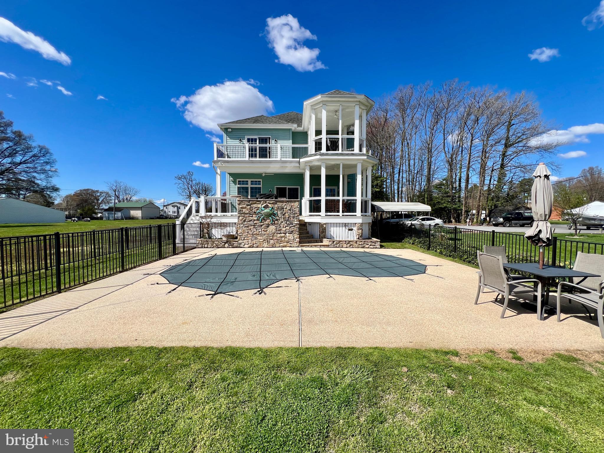 Luxurious Waterfront Oasis Awaits at 1419 Chesapeake Rd.

Immerse yourself in unparalleled comfort and lavish upgrades in this waterfront masterpiece. This home boasts an entertainer's dream with its expansive living areas and resort-style yard.
Inside, discover unparalleled luxury with high ceilings on both levels creating a spacious and airy feel. A whole-home water filtration system for pure, refreshing water throughout the house. Surround sound system extends to the outdoors, creating an immersive experience.
The radiant heated flooring in the kitchen, primary bathroom, and apartment bathroom provides ultimate comfort. Enjoy a steam shower and jacuzzi tub in the primary bathroom for a spa-like retreat.
This luxury home is quipped with geothermal air and heat with dual zones ensures efficient climate control.
Tankless water heaters in both the main house and apartment deliver endless hot water.
The gourmet kitchen caters to your culinary desires including a pot filler faucet for effortless filling of large pots, double oven for multifaceted cooking, wet bar with wine chiller and mini fridge, cabinetry-integrated refrigerator for a sleek and modern aesthetic. Entertain in style with dual-sided fireplaces create a warm ambiance in both the living room and primary bedroom. A Gas line conveniently fuels your outdoor kitchen grill for maximum enjoyment.
Unwind and rejuvenate outdoors at the saltwater pool with Badu swim jet offers endless exercise and relaxation, the pool is heated to extend the swimming season.
Trex decking offers a durable and low-maintenance entertaining space overlooking the pool and water, extending to the pier, offering a 10,000 lb. boat lift makes launching and retrieving your vessel a breeze.
The fully-equipped in-law suite apartment above the garage provides privacy and comfort for guests or family, complete with a chair lift for accessibility.
A Generac generator ensures peace of mind during power outages.
This exquisite waterfront property offers everything you could desire for a luxurious and comfortable lifestyle. Schedule your showing today!