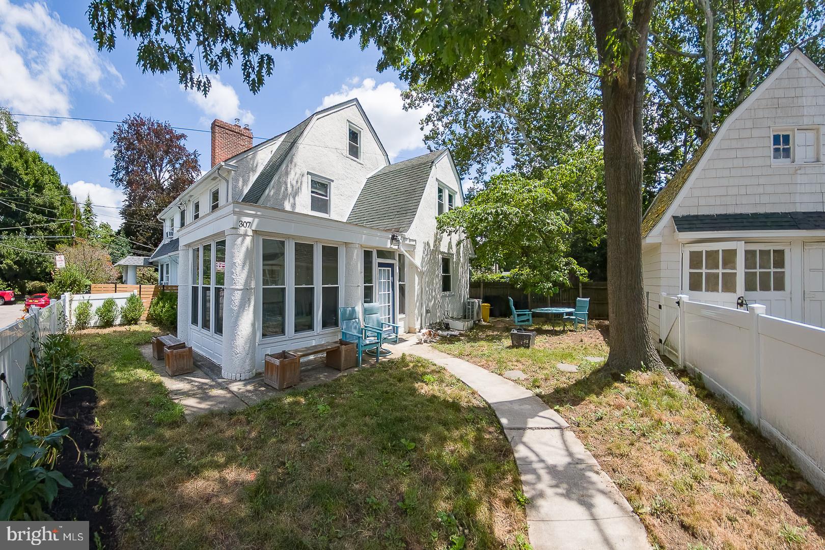 Welcome home to this charming and beautifully updated 4-bedroom, 2.5-bath twin in the heart of desirable Bala Cynwyd. Perfectly situated within walking distance of local shops, restaurants, the Cynwyd Train Station, and the scenic Cynwyd Heritage Trail, this home offers the ideal blend of neighborhood charm and everyday convenience. A cozy enclosed sunroom welcomes you inside and provides the perfect space to relax year-round. The bright formal living room features a classic wood-burning fireplace and beautiful hardwood floors that continue throughout much of the home. The formal dining room flows seamlessly into the updated kitchen, creating an ideal layout for both everyday living and entertaining. The kitchen is appointed with quartz countertops, white wood cabinetry, black stainless steel appliances, a breakfast bar, and a separate pantry area for exceptional storage. A convenient powder room completes the main level. The second floor features a spacious primary bedroom with two closets, two additional generously sized bedrooms, and a beautifully updated hall bathroom with a double vanity, tub/shower combination, and linen closet. The third floor offers a private fourth bedroom, a separate full bathroom with a tub, and additional storage space, making it perfect for guests, a home office, or an au pair suite. The lower level provides a laundry area and abundant storage. Outside, enjoy the wonderful level fenced backyard, ideal for entertaining, gardening, or play. A  driveway, one-car garage with a Level 2 electric vehicle charger complete this exceptional home. Located in the award-winning Lower Merion School District and just minutes from Center City Philadelphia, major highways, parks, and shopping, this move-in-ready home offers the perfect combination of character, modern updates, and an unbeatable location.