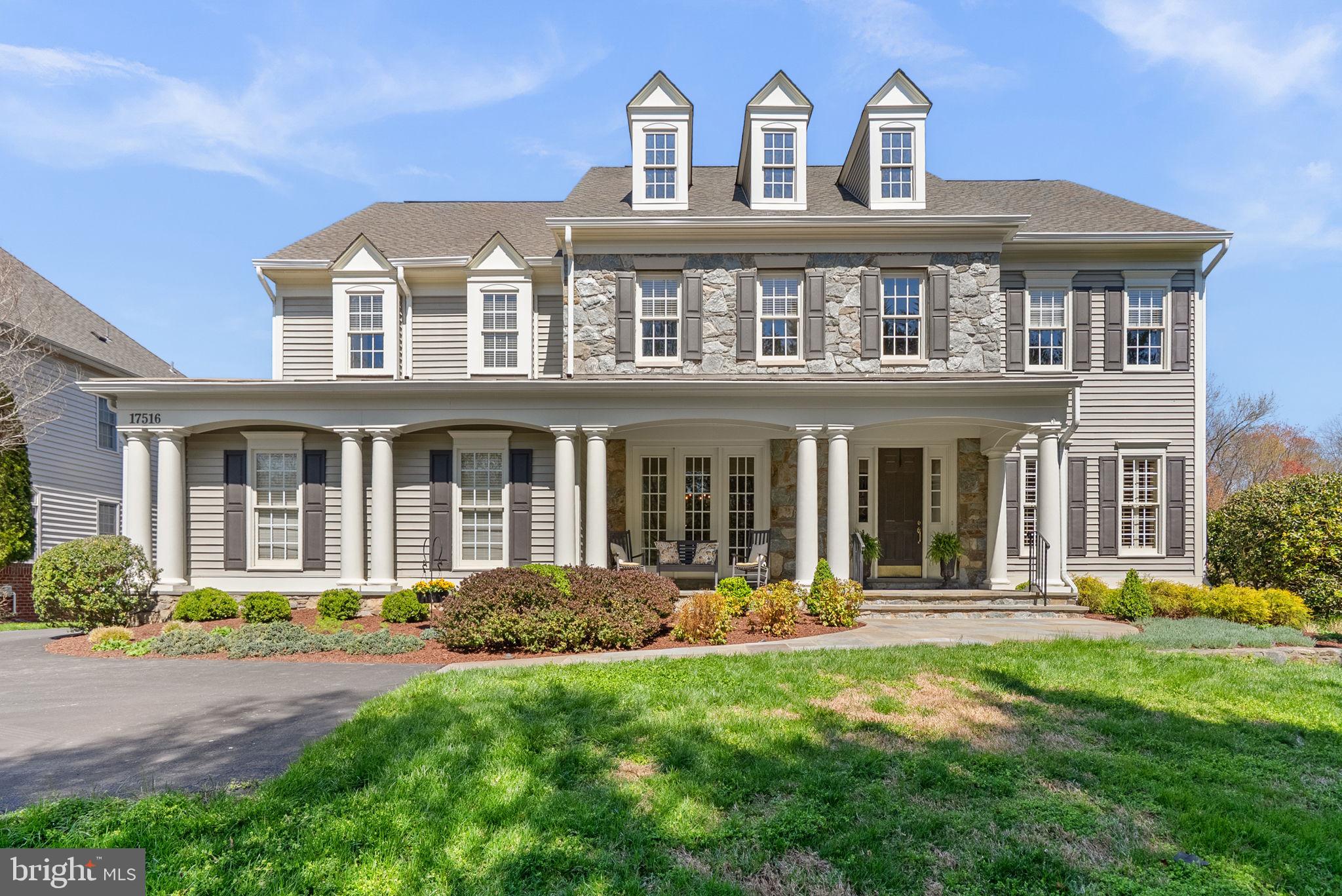 Nestled in the desirable Bancroft neighborhood in Sandy Spring, MD, this exceptional residence offers a peaceful suburban setting with access to walking paths, jogging trails, and tot lots—blending tranquility with everyday convenience.

This elegant stone and vinyl two-story Colonial presents 5 bedrooms, 4 full baths, and 1 half bath, encompassing a total of 7,078 square feet, including approximately 6,048 square feet of finished living space. A slate walkway leads to an expansive front porch, while the rear outdoor space is highlighted by a gorgeous and substantial slate patio with retaining walls and a fireplace—creating a refined setting for outdoor living and entertaining.

Upstairs, four well-appointed bedrooms include a luxurious primary suite featuring a private sitting room and a spa-inspired bath. A secondary bedroom offers its own en-suite bath, while bedrooms three and four are connected by a Jack-and-Jill bath.

The main level is introduced by a grand two-story foyer. To the right of the foyer, a formal living room and a private office or den with custom built-ins are thoughtfully positioned, along with a convenient half bath. To the left of the entry, a spacious formal dining room is ideal for entertaining. Beyond the staircase, a spacious and beautifully appointed family room with a gas fireplace extends seamlessly to the kitchen, creating a warm and inviting gathering space. The kitchen is fully equipped with a center island cooktop, double wall oven, granite countertops, and generous workspace.

Just off the kitchen, a light-filled morning room offers casual dining with direct access to a covered deck overlooking the backyard. The opposite side of the kitchen features a built-in desk area, mudroom, laundry room, and access to the attached two-car garage.

The finished lower level features a full level walkout to the slate patio and is designed for entertaining, offering an oversized recreation room, a separate game room, and a bar lounge area—perfect for gatherings and extended living.