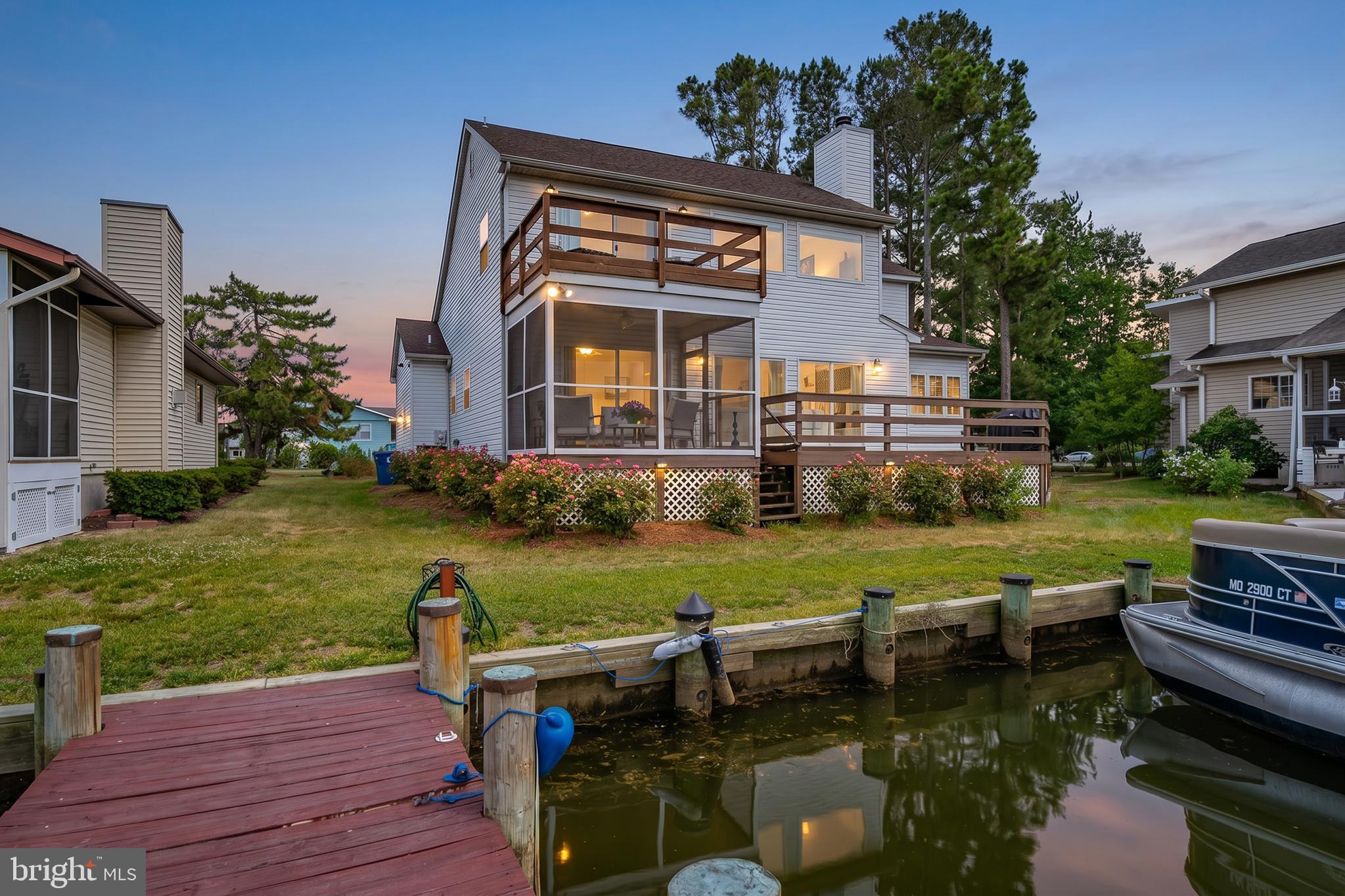 Exceptional canal-front home with a pier and direct access to the bay. Thoughtfully updated throughout, this spacious 4-bedroom, 2.5-bath home offers the potential for a 5th bedroom and features new windows, flooring, renovated bathrooms, and an updated kitchen. Modern glass stair railings add a stylish contemporary touch, while the primary suite boasts a generous walk-in closet. Enjoy stunning water views from the spacious living areas, screened porch, and multiple decks. Outside, the beautifully landscaped and fenced yard provides the perfect setting for entertaining or relaxing by the water. Additional features include a fireplace, attached 2-car garage, and pier for boating, fishing, and crabbing right from your backyard. Ideally located just around the corner from one of Ocean Pines waterfront beach clubs, residents can enjoy convenient access to a pool, sandy beach area, and waterfront recreation. Enjoy all the amenities Ocean Pines has to offer, including pools, golf, marina, yacht club, parks, and beach club access. Whether you're looking for a year-round residence, vacation getaway, or investment opportunity, this exceptional waterfront property offers the best of coastal living.