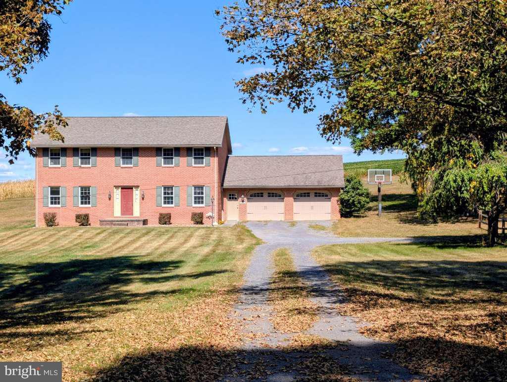 Welcome to Country Living! Nestled on 3.316 scenic acres in beautiful Bedford County, this charming two-story home offers the best of rural living with all the space and privacy you've been dreaming of. On your way, you'll pass the renowned Boyer Orchard—a local favorite—setting the tone for the peaceful lifestyle that awaits. With over 2,400 square feet of living space, this home is perfect for hosting family gatherings and holidays. Whether you're inviting the in-laws or enjoying a quiet retreat, there's room for everyone—without sacrificing your privacy. Out front, a basketball hoop invites fun and friendly competition, while the inground heated hopper pool offers the perfect way to relax after a long day. Inside, you'll find a warm and inviting layout. The first floor features: A half bath, a mudroom that could double as a small office or study, a gathering room complete with a charming brick fireplace. The country-style kitchen is a true showstopper, featuring custom cherry cabinets crafted from wood sourced directly from the property. Granite countertops and a farmhouse sink complete the rustic elegance, making this kitchen the heart of the home. Enjoy sit-down meals in the formal dining room, or unwind in the living room highlighted by a unique stained glass window that adds character and charm. Upstairs, you'll find: Three spacious bedrooms, including a primary suite, a full bath, ready for your personal touch with a few minor updates. Newer wall-to-wall carpet for a fresh and cozy feel. Stay warm all winter long with radiant heat that provides consistent comfort throughout the home. Outside, the possibilities are endless. With over 3 acres of open land, you have the space to: Tinker or work on hobbies in the garage, keep animals in the stable located at the corner of the property, or simply enjoy the privacy and peaceful surroundings. This home is the epitome of country living—peaceful, private, and full of charm. It truly must be seen to be appreciated.