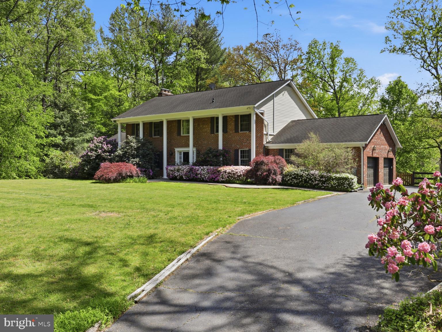 Fairfax Station luxury at its finest! Welcome to this exceptional 5-bedroom, 4.5-bath estate on 5 private acres in the sought-after Smoke Rise community—nestled at the end of a quiet cul-de-sac and offering the perfect blend of privacy, space, and refined living.
Designed for both everyday comfort and elevated entertaining, this home features hardwood floors on the main and upper levels and an expansive family room with a wood-burning fireplace, custom built-ins, and direct access to a spacious rear deck overlooking a serene, wooded setting.
The fully renovated chef’s kitchen is truly the heart of the home, showcasing a massive center island, quartz countertops, stainless steel appliances, farmhouse sink, custom cabinetry, a large pantry, and a wall of windows that brings the outdoors in.
A main-level bedroom with fireplace and en suite bath offers the perfect option for multigenerational living or an au pair suite, along with the convenience of main-level laundry, a breakfast nook, and formal dining room.
Upstairs, the luxurious primary suite features a private sitting room or office, an oversized walk-in closet, and a spa-like bath with soaking tub, walk-in shower, and dual vanities. Three additional spacious bedrooms complete the upper level.
The fully finished lower level offers incredible flexibility with a recreation room, kitchenette, game room, exercise space, full bath, and ample storage.
Equestrian enthusiasts will appreciate this horse property, complete with a six-stall barn with water and electricity, riding ring, paddock, and creek—all set within a picturesque landscape with mature trees and lush surroundings.
Additional highlights include a side-load two-car garage, expansive outdoor living spaces, and close proximity to Clifton, Burke VRE, major commuter routes, shopping, and dining.
A rare opportunity to own a private Fairfax Station estate with equestrian amenities—this is the lifestyle you’ve been waiting for.