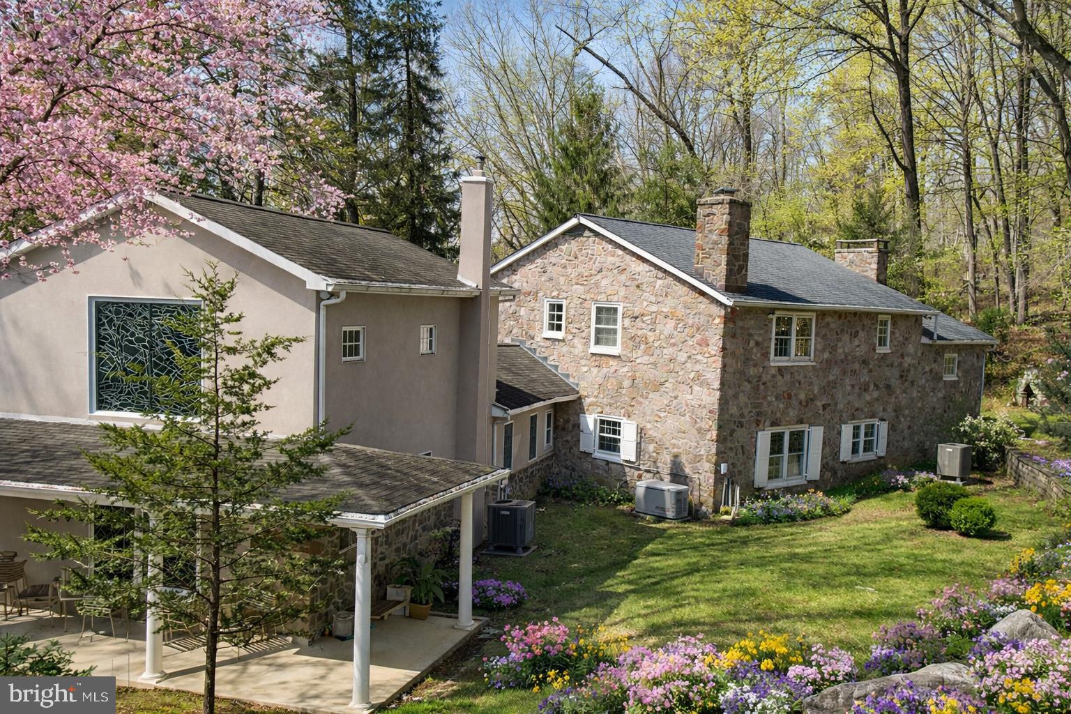 Tucked behind Spring Mountain Ski Area and bordered entirely by the scenic Perkiomen Creek, this remarkable 23-acre gated property offers a rare opportunity to own a truly private retreat in the heart of Montgomery County.

A winding drive leads through stately gates and into a serene landscape of mature trees, open grounds, and peaceful creekside vistas. With water wrapping the property, every corner feels connected to nature—creating an unparalleled sense of privacy and escape just a short drive from the Main Line and Philadelphia.

The main residence blends timeless character with warm, inviting spaces. Sunlit interiors feature hardwood flooring, exposed beams, and multiple gathering areas designed for both everyday living and entertaining. Expansive windows frame views of the surrounding landscape, bringing the outdoors in throughout the seasons.

The property is uniquely equipped as a private compound, offering multiple structures that provide flexibility for a variety of lifestyles. A detached guest residence with a two-car garage presents an ideal opportunity for extended family, an au pair suite, or creative renovation. A charming log cabin adds additional character—perfect as a studio, workshop, or quiet retreat space.

Outdoors, the property becomes the true centerpiece. Gently rolling grounds, wooded areas, and open clearings offer endless possibilities—from recreation and relaxation to hosting unforgettable gatherings. The creekside setting, with its natural beauty and tranquil sound of flowing water, creates an atmosphere that is both peaceful and inspiring.

Preserved under Pennsylvania’s Clean & Green program, the property benefits from significantly reduced taxes while maintaining its natural beauty and open space.

Whether envisioned as a private estate, a weekend retreat, or a multi-generational compound, this one-of-a-kind property offers a lifestyle rarely found in the region—where land, water, and privacy come together in perfect harmony.