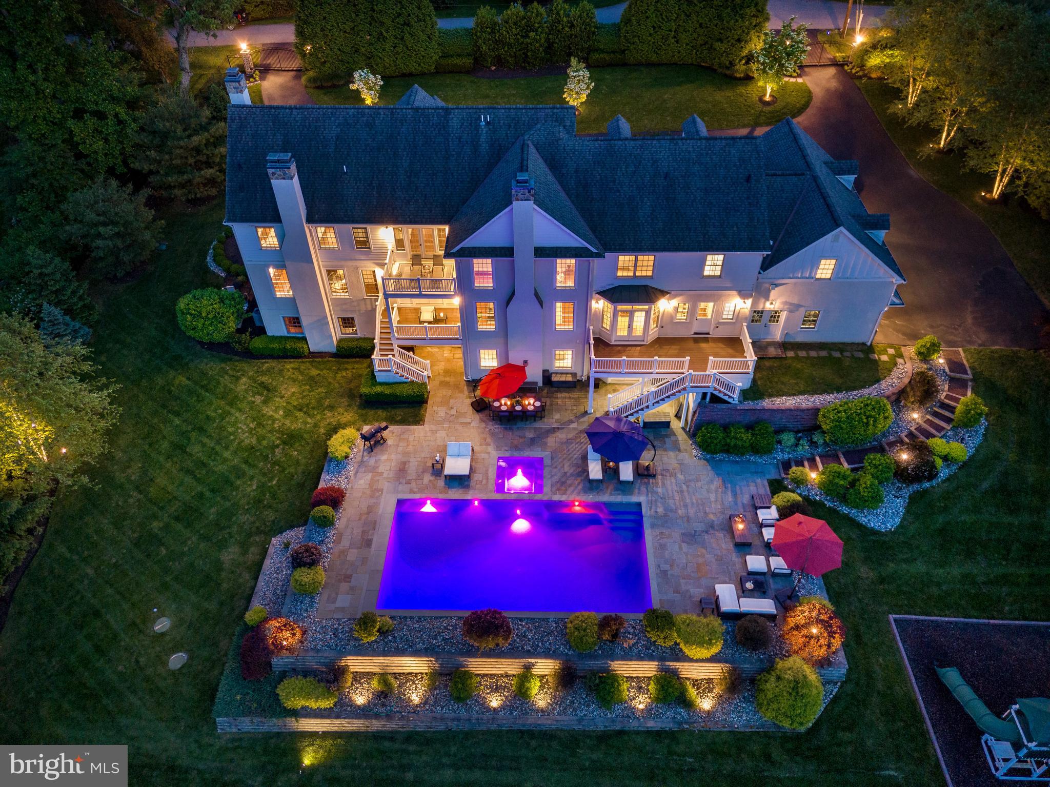 OPEN HOUSES FOR THE WEEKEND ARE CANCELED: Nestled within the lush embrace of mature trees and verdant landscapes lies 647 Andover Road—a majestic haven of timeless elegance and modern luxury in Newtown Square. Concealed from the world by a canopy of greenery, this private estate sprawls across 3.8 acres of enchanting park-like surroundings in the prestigious enclave of Aronwold. Boasting 9,486 square feet, this magnificent home features 5 bedrooms, 4 full bathrooms, and 3 half baths.

Pass through the gates, guarded by stoic stone pillars, and be greeted by a grand entrance boasting a three-car garage and a regal half-circle driveway. Crafted by Main Line Design/Build, Inc. in 2014, this exquisite abode is a testament to bespoke craftsmanship and refined living.

Step inside to discover a world of opulence and sophistication. A grand foyer welcomes you with newly finished hardwood floors, guiding your gaze towards decks that overlook the mesmerizing grounds, complete with a heated in-ground salt water pool and year-round spa. The living room beckons with a custom fireplace and sweeping views, while the expansive formal dining room exudes elegance with its ornate moldings and crystal chandelier.

The custom-paneled library, featuring a gas fireplace and a coffered ceiling, exudes a cozy and inviting ambiance.

The heart of the home, a gourmet kitchen by Paradise Custom Kitchens, awaits with Bianco Carrara marble accents, top-of-the-line Wolfe and Sub-Zero appliances, and a sprawling center island. Adjacent, the spacious great room with soaring 20-foot ceilings invites relaxation by a stone fireplace, offering the perfect space for gatherings with loved ones. The walk-in pantry closets, two powder rooms, full laundry room, locker, and mud room are located just off the kitchen.

Ascend the grand staircase to find respite in the primary suite, a sanctuary of tranquility featuring a gas fireplace, coffered ceilings, and a luxurious Arabascata marble bath with heated marble floor, soaking tub, oversized shower, and two walk-in closets. Additional bedrooms await, each a sanctuary of serenity with custom-tiled baths and bespoke finishes. Completing the floor is an incredible bonus room that could be used as a playroom or additional bedroom.

The allure extends to a fully finished walkout lower level where entertainment flourishes with an in-home movie theater, bespoke wine cellar, game room enclave, gym, separate laundry and utility room, and powder room—all opening seamlessly to the outdoor oasis of a meticulously designed flagstone patio with salt water pool and year-round jacuzzi. A Pentair control system, Sol-Air automated pool cover, and Sta-Rite pool heater (new in 2023) make maintaining the pool a breeze.

Beyond this extraordinary estate lies a world of convenience and opportunity. 647 Andover Road is located a mere 0.6 miles from Aronimink Country Club (only 3 minutes by car) and is nestled within the acclaimed Marple Newtown School District.

With state-of-the-art systems like security gates, a generator, an outdoor Lutron lighting system, irrigation control, and proximity to major roadways for easy access to Philadelphia and Wilmington, this is a residence where every comfort and convenience has been meticulously considered. Don't miss your chance to own this once-in-a-lifetime masterpiece—where luxury, tranquility, and convenience converge in perfect harmony. Welcome home to 647 Andover Road—your private sanctuary awaits.