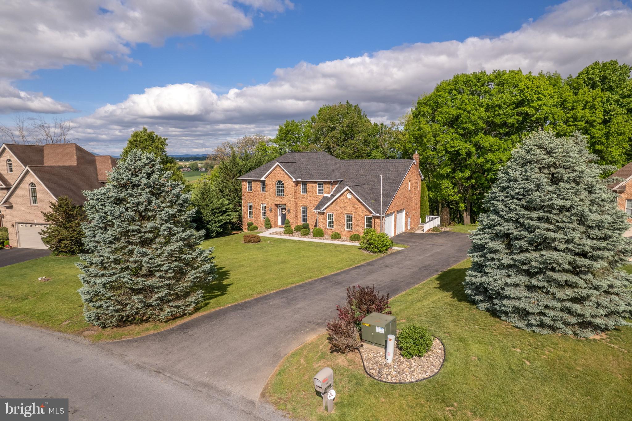Video Tour is a MUST SEE! Ask for it Today!
Where Luxury Lives — And Nature Awaits Just Beyond Your Back Door
This brick colonial in the Greencastle Greens Golf Community delivers over 4,650 finished square feet of thoughtfully upgraded living space — and then offers something truly rare: your own private pathway to nature, steps from the Conococheague Creek.
From the moment you enter, the scale and quality make an impression. The gourmet kitchen is where this home truly earns its reputation. Stretching 26x13 feet with over 40 feet of counter space, this is a kitchen that handles everything from quiet weekday breakfasts to full holiday gatherings without breaking a sweat. The 10-foot island anchors the space beautifully, wrapped in Kashmir White granite and surrounded by LifeArt solid wood cabinetry with furniture-grade finishes, dovetail drawer construction, 42-inch wall cabinets, and 65 soft-close doors and drawers — including three glass-front display cabinets that add a touch of elegance. A gas cooking range, stainless appliances, convenient pantry, recessed lighting, casement windows, and a reverse osmosis drinking water system complete a kitchen that is as functional as it is stunning. A sliding door opens directly to the rear deck, making outdoor dining effortless.
The sunken family room — with its gas fireplace and French doors — flows seamlessly to a 30x14 rear deck overlooking a wooded backdrop built for every season.
Upstairs, the primary suite is a world of its own: trayed ceilings, a private sitting room with a gas fireplace, an intimate morning coffee balcony, and a spa-inspired bath complete with dual vanities, a jetted soaking tub, and a glass walk-in shower.
The lower level raises the bar entirely — a 48-foot rec room anchored by a 17-foot horseshoe granite wet bar with Brooklyn loft-style brick wall accents, a full bath, and a dedicated theater room with projector and screen. 
For peace of mind in 2020 the roof had a major upgrade to 50 Year Long-Life, IKO Dynasty/Cambridge Architectural Shingles and to give additional comfort and security, the heat pumps have been recently replaced; one in 2021 and the other in 2023.
Then step outside — and let the land tell its own story. A short walk through your wooded backyard opens up to over an acre of flat, open ground a few steps from the banks of the Conococheague Creek — and what awaits you there is nothing short of remarkable. This is the kind of land that invites you to slow down and build something meaningful. Pitch a tent and wake up to wild flowers and bird songs. Raise a pavilion for family gatherings under the trees. Carve out a meditation space where the sounds are mostly water, wind, and wildlife. Watch deer slip quietly through the tree line. Listen to ducks and geese settle onto the creek at dusk. Spot wild turkey moving through the brush, and squirrels working the canopy overhead. As evening falls, the soundtrack shifts — spring peepers, crickets, tree frogs, and the distant call of an owl fill the air in a way no playlist ever could. Why drive fifty miles for a weekend escape when yours is already waiting, just steps from your back door?
Located in the sought-after Greencastle-Antrim School District, minutes to I-81, with recent upgrades throughout.
Schedule your private tour today and experience everything this extraordinary home — and its land — has waiting for you.