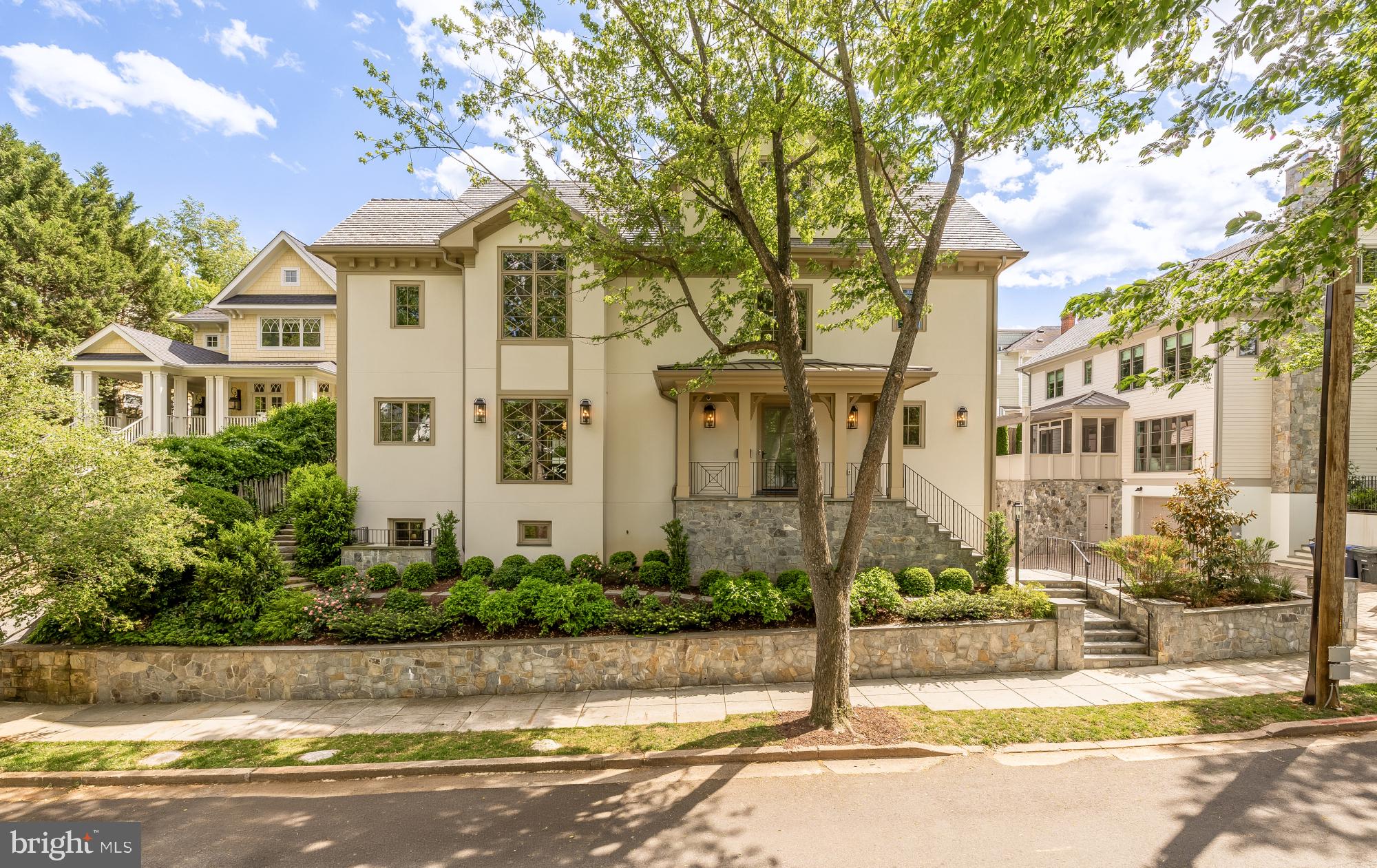 Nestled in Kent—one of Northwest DC’s most coveted and picturesque enclaves—this exceptional four-level single-family residence masterfully balances grand architectural scale with an inviting sense of lived-in warmth. Designed by renowned architect Chryssa Wolfe of Hanlon Design Build, the approximately 6,500-square-foot home is a striking study in light, proportion, and elevated modern design. From the dramatic entry sequence and extensive custom hardscaping to the wide-plank blonde hardwood floors and walls of floor-to-ceiling glass, every detail has been thoughtfully curated to create a bright, refined, and timeless aesthetic.

The main level unfolds through expansive, sun-drenched living spaces framed by oversized windows that flood the interiors with natural light. At the heart of the home, a spectacular chef’s kitchen is appointed with premium Wolf appliances, an oversized center island, and generous space—enough for multiple dining and living areas—equally suited for elegant entertaining and relaxed everyday living. Sophisticated finishes seamlessly connect each space, while two gas fireplaces provide warmth, intimacy, and architectural presence throughout. An integrated elevator services all four levels, offering exceptional comfort and convenience.

With seven generously scaled bedrooms and 5.5 baths, the home offers luxurious private retreats for both family and guests. The primary suite is a serene sanctuary, featuring expansive windows overlooking the front grounds and quiet, tree-lined street; and a spa-inspired bath anchored by a deep soaking tub designed for quiet relaxation. On the lower level, a dedicated wine cellar provides an ideal setting for collectors and entertainers alike.

Beyond the interiors, the rear grounds evoke a true resort-style escape. A heated in-ground pool is complemented by a fully equipped cabana and poolhouse, creating an extraordinary setting for summer entertaining and effortless outdoor living. The terrace extends naturally from the indoor spaces, allowing for a seamless transition to alfresco dining and lounging. Complete with an attached one-car garage and a four-car driveway, this remarkable Kent residence presents a rare opportunity to own a sophisticated, light-filled estate in the heart of the District.