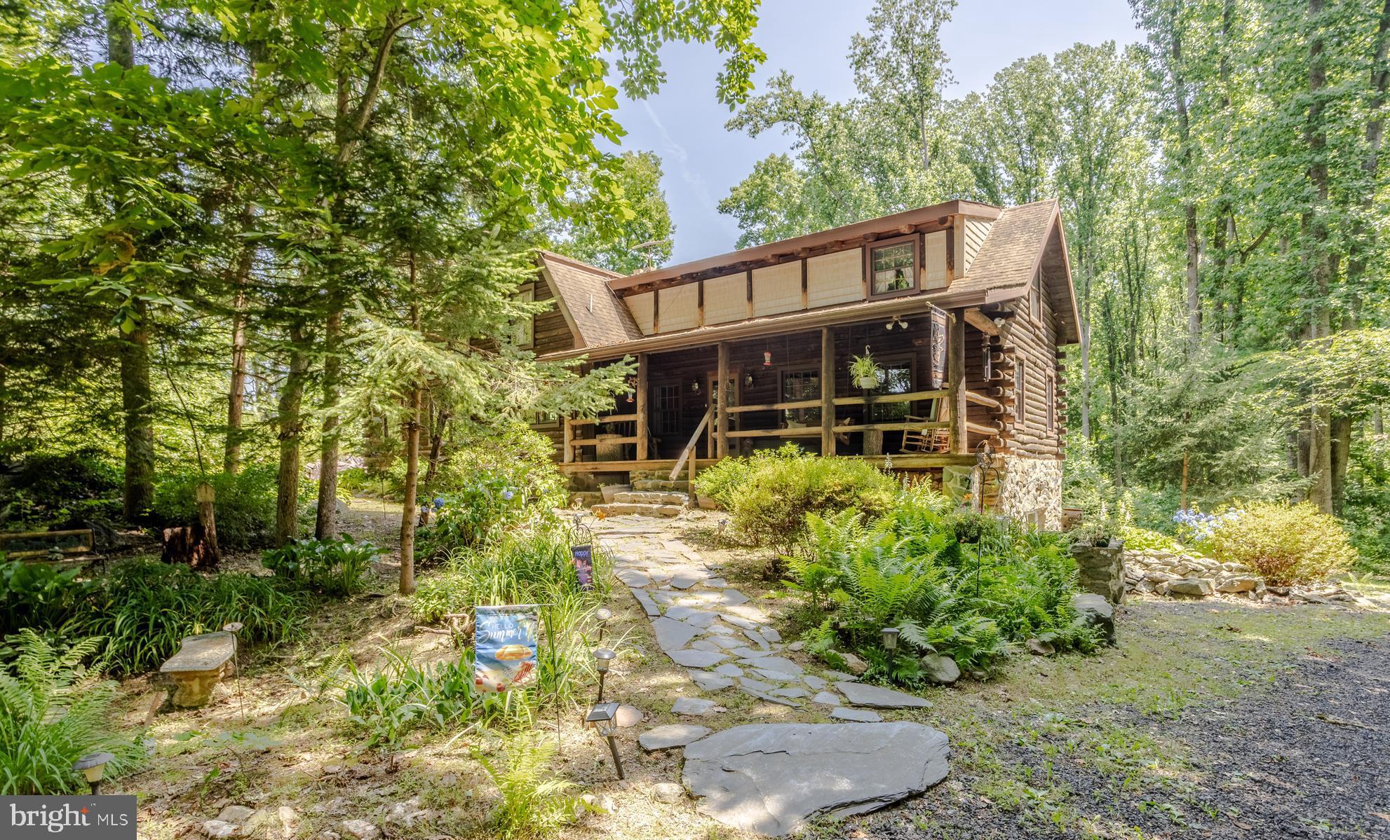 **Escape to your own private woodland retreat!** Nestled on nearly **7 acres** in the heart of Jarrettsville, this **custom-built log home**, lovingly owned by its **original owners**, offers a rare opportunity to enjoy peaceful living surrounded by nature. Located at the end of a shared driveway, the home is tucked among mature trees, providing exceptional privacy, breathtaking woodland views, and a tranquil setting unlike any other. 

Designed to embrace its natural surroundings, the home features **multiple covered porches** where you can relax with your morning coffee, unwind in the evening, or simply enjoy the sights and sounds of the forest in every season. Whether you're watching wildlife, listening to birdsong, or admiring the changing colors of the trees, every window offers a picturesque view.

Inside, you'll find over **2,600 square feet** of above-grade living space featuring **5 bedrooms, 2 full baths, and 1 half bath**. The warm, inviting interior showcases exposed log walls and beams, a stunning stone wood-burning fireplace, spacious formal living and dining areas, a kitchen with an island and pantry, and generous bedroom sizes. The full walkout basement offers over **1,500 square feet** of additional space, complete with a workshop and endless possibilities for future expansion. 

The property is currently enrolled in the **Forest Stewardship Program**, helping preserve the beauty and health of the surrounding forest while promoting responsible land management. Buyers should note that the property **may be removed from the program** if desired, offering flexibility for future use.

If you've been dreaming of a home where privacy, nature, and craftsmanship come together, this exceptional property is ready to welcome its next chapter. Experience the beauty of country living while remaining just a short drive from local conveniences.