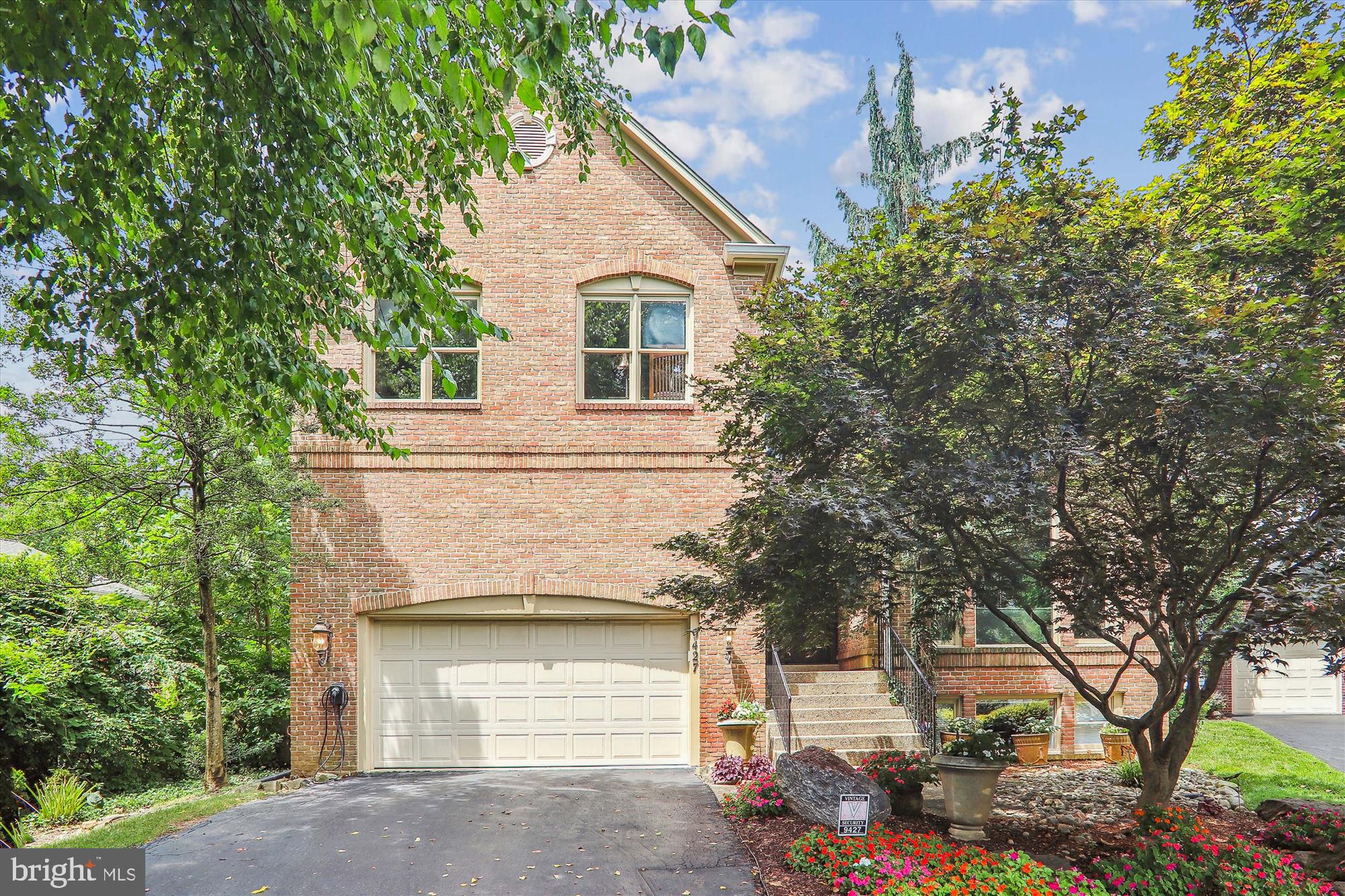 Discover the perfect blend of luxury and comfort in this artful newer build located off Spruce Tree Circle. This stunning home offers 6 bedrooms and 4.5 bathrooms, set in a private and beautifully landscaped setting. As you approach, the beautifully landscaped front yard invites you towards the curved wooden double front doors. Step into the grand foyer, where a stunning chandelier and soaring 2-story ceilings welcome you. The lovely columns and hardwood floors lead you into spacious rooms filled with character.

The living room boasts raised coffered ceilings, large decorative windows, and stunning flooring, creating an elegant yet inviting atmosphere. The cozy family room features a cathedral-style ceiling, a magnificent stone fireplace, and detailed windows on either side, perfect for family gatherings or quiet evenings. Adjacent to the family room, the large formal dining room is beautifully finished with exposed wood beams and surrounded by windows that bathe the space in natural light. The dining room seamlessly flows into the open-concept kitchen, equipped with stainless steel appliances, all-white cabinetry, and a convenient island that makes cooking a breeze.

The first-floor primary bedroom suite is a true retreat, designed with stunning stained-glass windows and a raised ceiling that adds character. The luxury bathroom is outfitted with a large soaking tub, an oversized beautifully tiled shower, and a double vanity, offering a spa-like experience. 

Upstairs, you’ll find three additional bedrooms and two full bathrooms, providing ample space for family or guests. The spacious lower level is wonderfully finished with workout areas, a huge office, a wine cellar, and an additional family room, catering to all your lifestyle needs.

The cozy and tranquil backyard is your private oasis, backing to the trees of the Bethesda Trolley Trail. Enjoy evenings by the fire pit or relaxing on the flagstone patio, surrounded by nature. Don't miss the chance to make this spectacular home yours. Schedule an appointment today and experience all that this home has to offer. This property won’t stay on the market for long—act now!