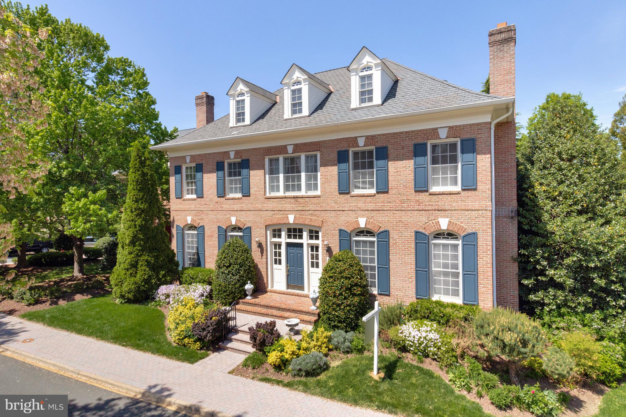 Welcome to this stately and elegant Colonial residence, perfectly situated in the highly coveted Evans Farm gated community. Spanning over 5,000 square feet, this 4 bedroom, 5.5 bath home is a true masterpiece of architectural design and craftsmanship.  The home boasts exquisite trims and molding, with rich hardwood floors gracing both the main and upper levels. The kitchen features a Viking gas stove with a vent hood, a Sub-Zero refrigerator, and a spacious eat-in area. A convenient pantry and adjacent family room, with a gas fireplace that creates a perfect space for both entertaining and everyday living. For those who appreciate refined living, the formal dining room, complete with its own wood-burning fireplace, is ideal for hosting elegant dinners. The sophisticated living room, also with a wood-burning fireplace, provides a serene setting for relaxation. The upper levels are equally impressive, with a spacious primary suite that serves as a luxurious sanctuary. This suite includes a cozy sitting room, dual walk-in closets with custom organizational systems, and an expansive primary bathroom. The bathroom features dual vanities, a large jacuzzi tub, tile floors, a walk-in shower, and a separate water closet. The secondary bedrooms are generously sized, each with their own full bath, providing comfort and privacy for family and guests. The lower level offers a spacious game room and a wet bar, a den/additional bedroom with en-suite full bath, and access to the three-car garage. Evans Farm is a gated community of 143 luxury residences in McLean, Virginia, situated on the historic site of the former Evans Farm between Chain Bridge Road and Dolley Madison Boulevard, close to the George Washington Parkway and Potomac River.