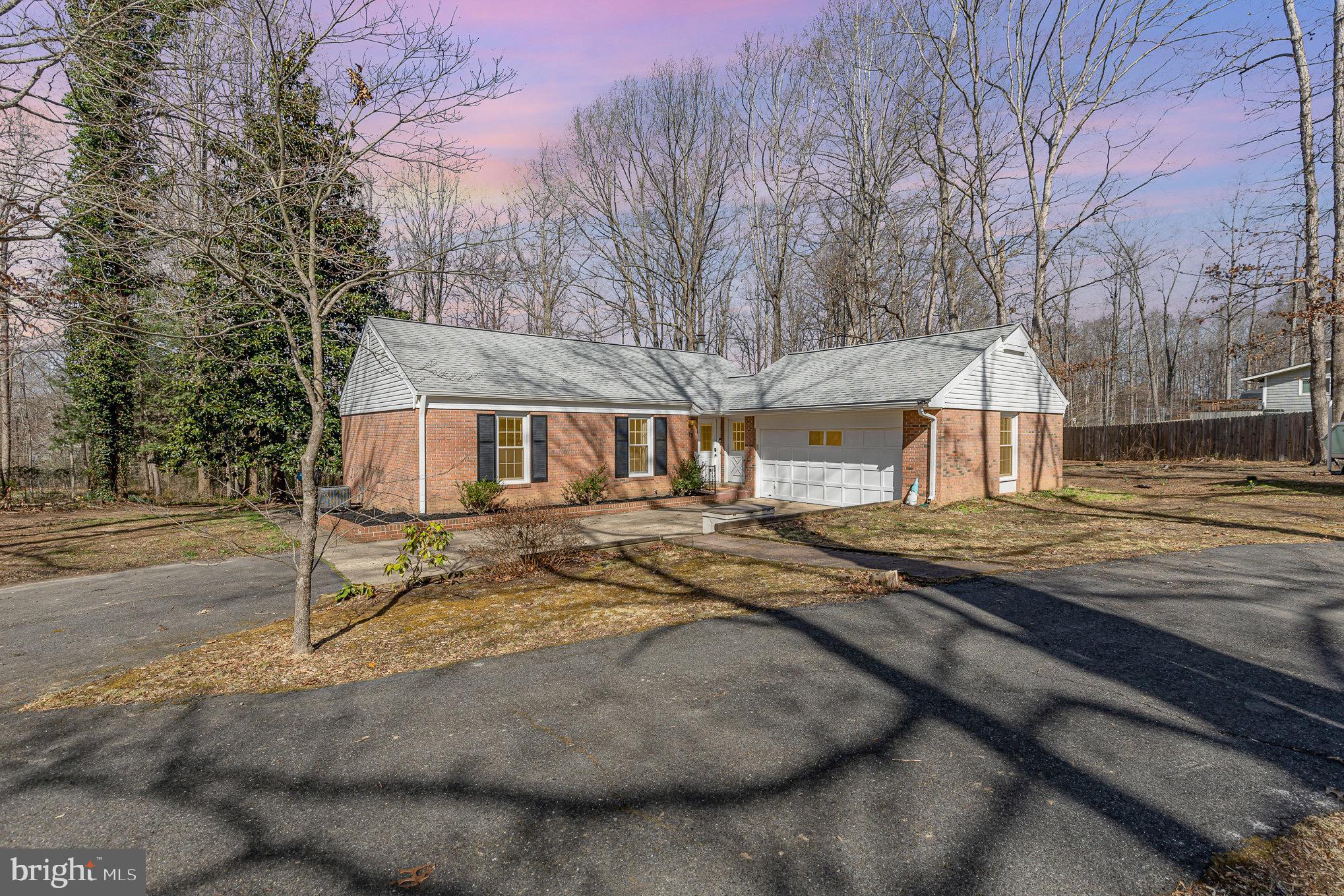 Welcome home! This adorable home is nestled on a private 1.26acre lot with both cleared and wooded areas, plus a tranquil creek at the rear, this completely renovated gem is ready for you to move right in & enjoy! Home features  3 spacious bedrooms, 2 baths, an open layout with tons of natural light, and a beautiful corner wood burning fireplace. Home was completely renovated in 2019, which included brand new white kitchen cabinets, sleek stainless steel appliances, gorgeous granite countertops, modern light and plumbing fixtures, plus all-new flooring throughout. Remodeled bathrooms, including a chic shiplap wall and stylish barn doors (2020). Enjoy the multi-level deck and patio that overlook your expansive, private backyard—perfect for entertaining or relaxing. Oversized 2-Car Garage, includes shelving &  work area, ideal for any  extra storage, also equipped with an additional hookup for an extra washer/dryer. Newer roof (2021), HVAC (2023), water heater (2018), whole house water filtration system (2020), washer/dryer (2020), dishwasher (2024), deck (2024) giving you peace of mind with updates you can count on!
With its charming curb appeal, extended circular driveway, and an inviting front yard, this home offers both comfort and style. Don’t miss out on the opportunity to own this beautiful, turnkey property!