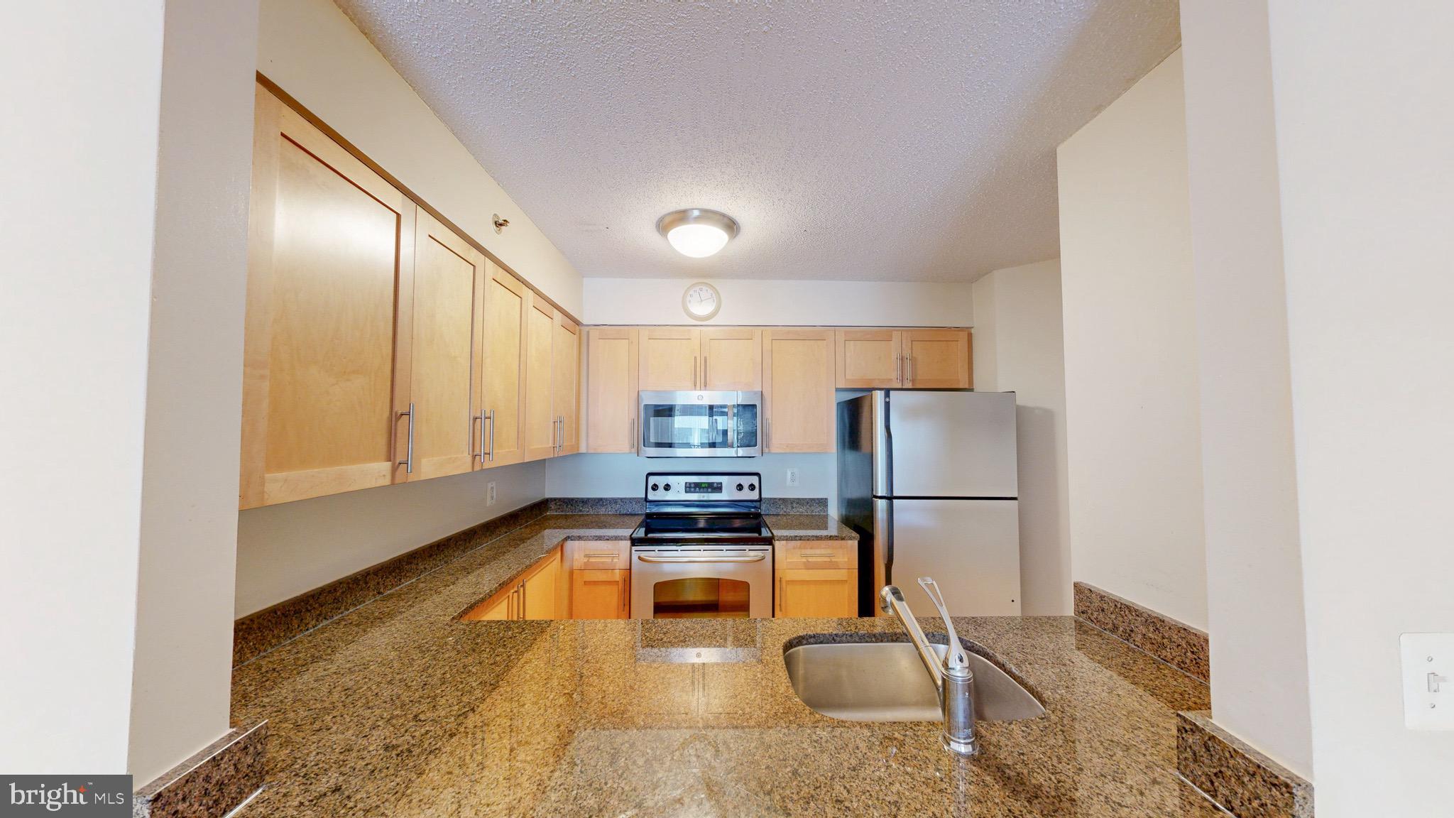 If you want to live in the Famous B-E-T-H-E- S-D-A come see this one ----- LARGE BETHESDA 1 + 1 CONDO -- --- LARGEST SQ FEET FOR a 1 + 1 in the Bldg -- Welcome to this spacious 1 Bedroom  +1 Bath, with Balcony, Hardwood floors in living area, carpet in bedroom, WASHER & DRYER IN UNIT & underground garage PARKING & STORAGE [ deeded separately & conveys ] . Updated kitchen with granite countertops, stainless appliances and breakfast bar. In the heart of Downtown Bethesda just steps to METRO, Shopping, Restaurants, Coffee, Grocery stores, the list goes on. Secure, Luxury condo building with concierge service, POOL & fitness center. Super convenient location just minutes to NIH, Walter Reed, DC, I-270, I-495. Check out the V Tour.  - BETHESDA at it's B-E-S-T!!!