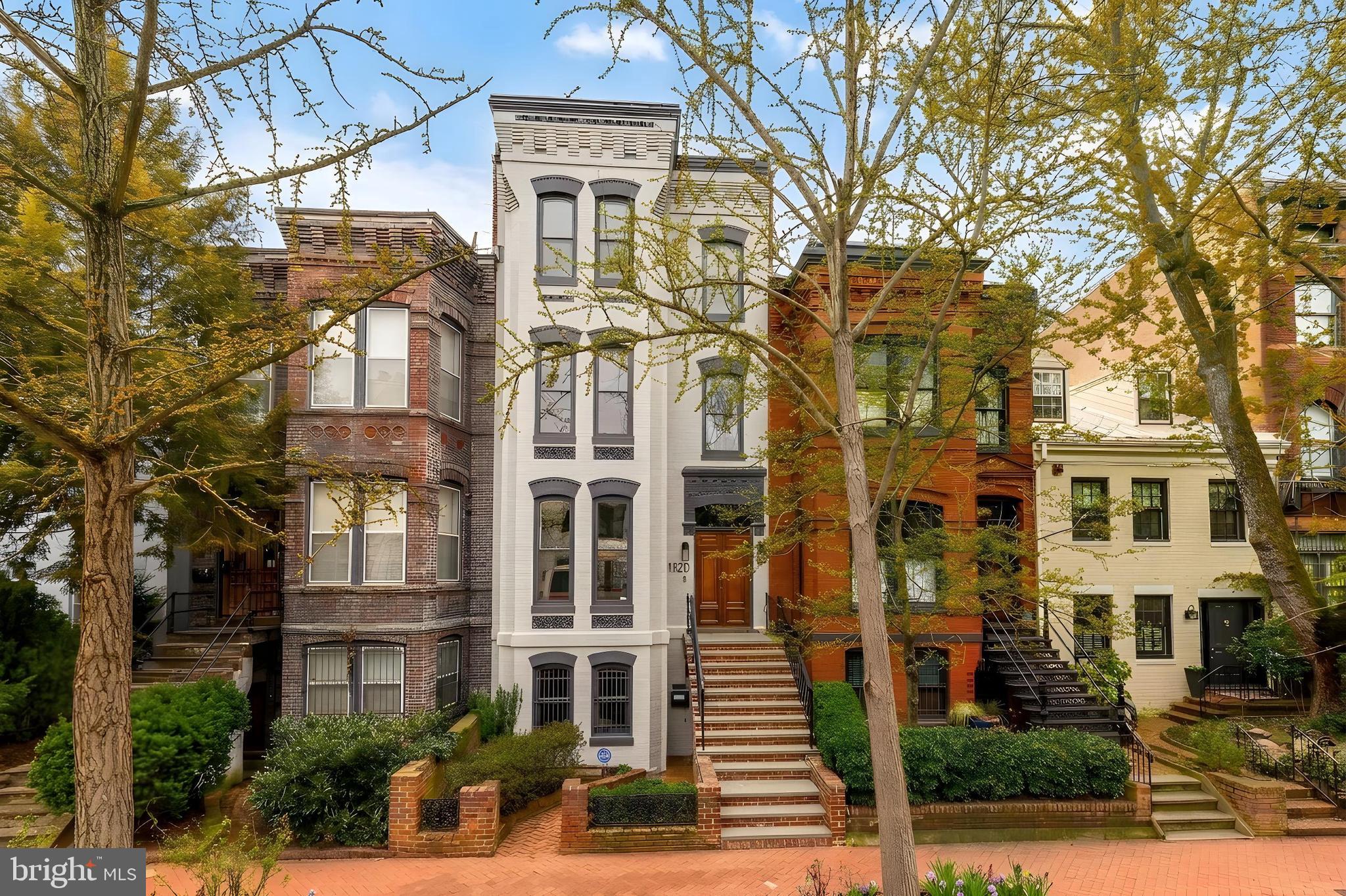 Perfectly positioned on one of the most beautiful blocks in the Logan Circle / Dupont Circle corridor, this fully renovated 1885 Victorian on coveted Corcoran Street masterfully blends preserved historic character with over half a million dollars in thoughtful, high-level improvements.
Spanning approximately 3,350 finished square feet across four levels, the residence offers exceptional scale, architectural presence, and rare income flexibility - all just 1.5 blocks to both 14th and 17th Street corridors.
The main home unfolds across three sunlit upper levels. A gracious entry atrium with skylight sets the tone, showcasing original staircase detailing, preserved hardwood floors, transoms, and period millwork. The elegant living room is anchored by a working fireplace and oversized windows, flowing seamlessly into a formal dining room distinguished by dramatic patio doors opening over a Romeo & Juliet balcony.
The kitchen renovation - designed by an actual professional chef!- is both refined and functional, featuring custom Mouser cabinetry, quartzite countertops, Thermador range and hood, Fisher & Paykel refrigerator, KitchenAid appliances, and curated designer lighting. Every bathroom in the home was fully renovated in 2022 with custom cabinetry and elevated finishes, creating a cohesive, turnkey experience.
The upper levels offer remarkable flexibility with the rare opportunity for two potential primary suites, each thoughtfully designed with scale, light, and architectural presence.
The second floor is flooded with natural light and features two spacious bedrooms, including one that lives beautifully as a primary suite. The show-stopping bathroom is a true design moment—an incredible wet room anchored by a soaking tub set within a massive glass-enclosed shower, framed by a window that brings in soft natural light. Designer tile selections and elevated fixtures create a spa-level experience that feels both modern and timeless. Laundry is conveniently located on this level, seamlessly integrated for everyday ease.
The third floor offers a fully private primary retreat. This suite features a beautifully appointed en suite bath with double vanity, custom wood detailing, a large walk-in shower, and a massive custom walk-in closet. A fourth bedroom on this level provides exceptional flexibility—ideal as a primary lounge, office, studio, or additional sleeping space.
Architectural details elevate the entire experience, including a stunning built-in library overlooking the entry foyer below, creating a dramatic sense of openness and vertical connection throughout the home. A separately cooled wine room adds another rare and thoughtful amenity for collectors and entertainers alike.
Refined, flexible, and architecturally striking—these upper levels deliver both function and wow factor in equal measure.
The separately accessed lower-level apartment is fully renovated (2022) and legally permitted with a Certificate of Occupancy. Featuring its own kitchen, full bath, washer/dryer, separate electric meter, and both front and rear egress offering meaningful income or flexible guest accommodations.
The private rear patio leads to rare TWO CAR off-street PARKING with repaved surface (2025) and rear landscape lighting. The one-way block limits through traffic, enhancing privacy and charm, while still placing you moments from acclaimed restaurants, boutique shopping, Whole Foods, and Studio Theatre. This is a turnkey, historically rich yet thoroughly modernized Victorian - offering architectural integrity, investment upside, and an unbeatable location in the heart of DC.