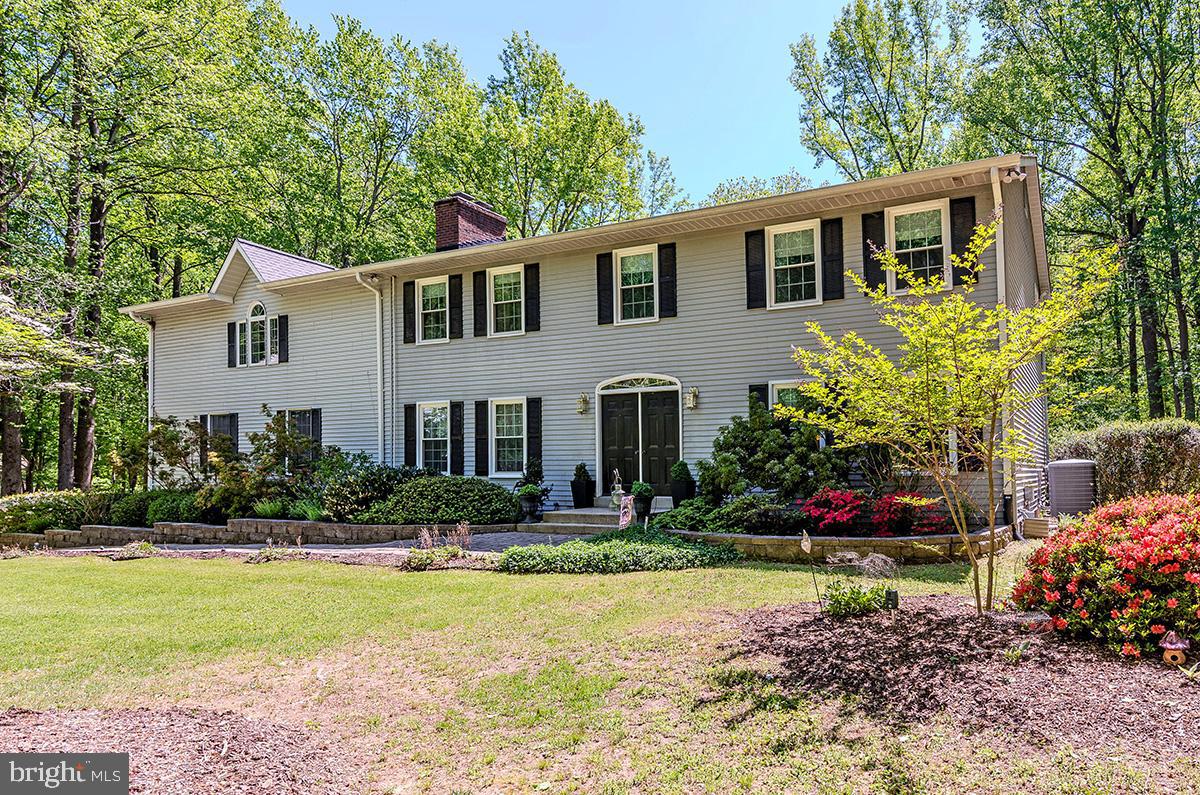 New price, new opportunity for you! Welcome to this lovingly maintained 4 bedroom, 2.5  bath custom built home on 2.06 acres in Queen Anne Estates.  You'll fall in love with this one of a kind property providing over 4,700  total square feet at an amazing price and located in a hidden gem of a neighborhood! If you love a serene setting that transports you to a park-like retreat, this home is for you!  As you first arrive,  you'll be enchanted by the beautiful blooms provided by the mature dogwood trees, daffodils, and other flowers that put on a spectacular show. Upon entering the home itself, you'll first note the warm, wood floors featured throughout the house. The formal living room to your right is perfect for receiving guests. The separate dining room has charming French doors that lead out to the deck for endless entertainment options. You'll next move into the enormous kitchen with a plethora of cabinet space,  breakfast bar, and room for a breakfast table. Updates done in 2022 to include new quartz counters, backsplash, sink, flooring, and faucet!  The family room has a lovely brick fireplace for those cold winter months and the cute half bathroom rounds out this level. However, adjoining the family room you'll proceed through a glass paneled door to a set of stairs. As you reach the top, you'll be wowed by your discovery! A phenomenal upper level great room is perfect for the entire family to enjoy movies or game night, or even a gym and home office! It's sure to become your favorite space with its soaring ceilings and multiple windows that bathe the room in sunlight. Moving back downstairs, you'll take the center hall stairs to the upper level where the bedrooms reside. Here you'll find the primary bedroom with with its remodeled (2024) en suite bath! Additionally, your private balcony is accessed by french doors that overlook your backyard. What a perfect spot for morning coffee or evening cocktails for two! As you make your way down the hall, you'll discover 3 more good sized bedrooms and an attractive full bath. All bedrooms feature enviable wood floors and plenty of natural light. Returning to the stairs, you'll make your way down to the lower and final level of this impressive home. Here, you'll find yet another finished room, perfect as a reading room or a peaceful getaway with a bonus wood burning stove to keep you cozy. The remainder of the basement level is unfinished, so you can let your imagination guide you for use. Consider it the perfect storage space or potential for finishing in the future. The over sized two car garage can be accessed from this level as well as from your kitchen. Next, you'll want to explore the outside. Here you'll find a tranquil paradise to include your patio and deck for grilling or relaxing in your hot tub! Nature surrounds you with endless space for playing in the yard or perhaps the addition of a pool is possible. The firepit will surely be enjoyable for both summer nights or watching the leaves change in the fall. As if that's not enough,  the roof, gutters, gutter guards, and windows were installed in 2020, new water heater in 2024, and new water treatment system in 2025 to name just a few items to benefit from. You'll be sure to recognize this home presents an  exceptional value for the savvy buyer who values privacy while still having the convenience of being close to shopping and restaurants. With easy commutes to Annapolis, DC, Baltimore, and BWI airport,  this is the perfect location!
*All information provided by seller deemed reliable but should be independently verified for accuracy.