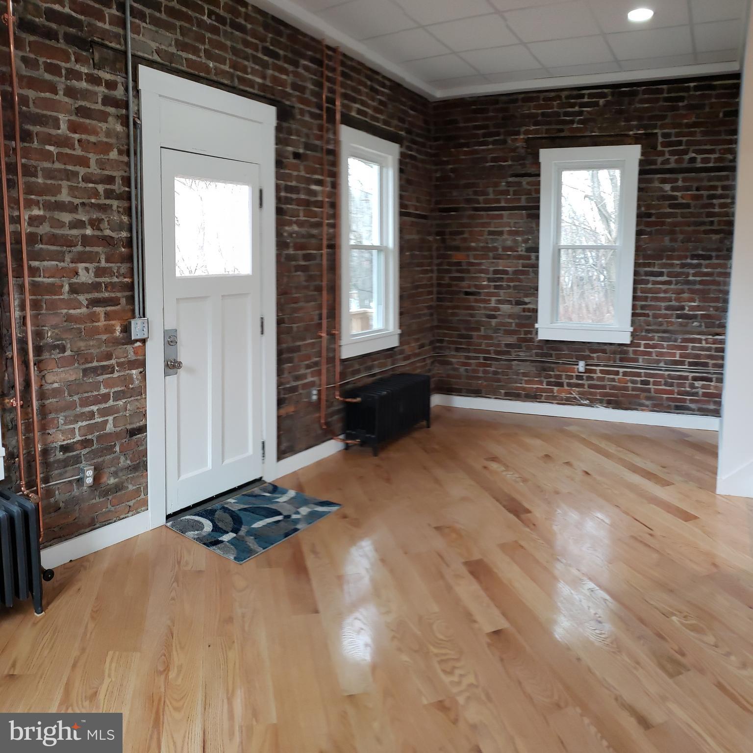 Charming Updated Home in Historic Cumberland.  This beautifully updated home combines historic charm with modern convenience. Featuring hardwood floors throughout, efficient radiant natural gas heat, and stunning exposed brick accents, it offers a cozy and inviting atmosphere. The home boasts three spacious bedrooms and two full baths, along with panoramic city views that you’ll love.  Located near a hiking trailhead, outdoor enthusiasts will appreciate the easy access to nature. The home has seen recent updates, including newer bathrooms, heating system, and roof—providing peace of mind for years to come. Best of all, it remains affordable, making it a great opportunity to own in a vibrant historic area.