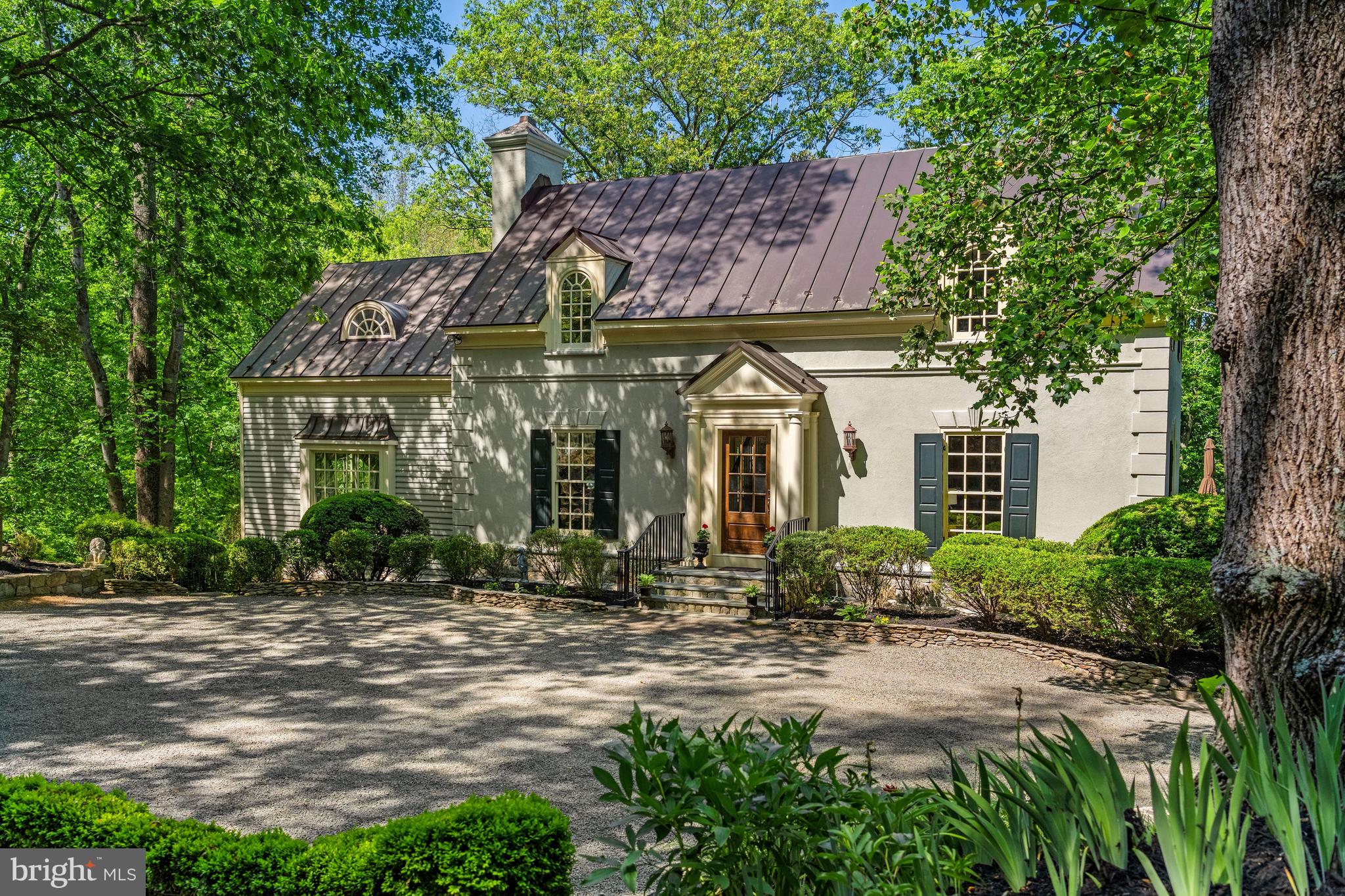 Set within the heart of Virginia’s Hunt Country, Goose Berry offers an exceptional blend of charm, privacy, and natural beauty just minutes from Middleburg. Tucked within an extremely private setting on a quiet country lane, the property enjoys a truly storybook atmosphere with spectacular views of historic Goose Creek. Surrounded by mature landscaping, stone walls, and sweeping water views, the property features a spring-fed pond, multiple decks, and beautifully curated outdoor spaces designed for peaceful country living and entertaining alike. Ideal as either a full-time residence or a luxurious weekend retreat, the setting is both serene and remarkably convenient.
The stucco and wood residence is rich in character, showcasing wide-plank pine floors, custom-painted interiors, and elegant imported finishes throughout. The main level centers around a chef’s kitchen with Carrara marble countertops, a butcher block island, premium appliances, and vintage Italian lighting. Gracious living and dining spaces flow seamlessly together, while the sun room is filled with natural light and opens directly to expansive decks overlooking the water and surrounding landscape. A wood-burning fireplace, custom window treatments, and Murano lighting from Venice further elevate the home’s sophisticated yet inviting atmosphere.
Upstairs, the spacious primary suite offers a walk-in closet and luxurious bath with a soaking tub and oversized shower, accompanied by an additional guest bedroom and bath. The lower level includes a family room with custom built-ins, French doors opening to the deck, and a third bedroom with an updated en-suite bath.
Equestrian amenities include a custom three-stall barn with tack room, wash stall, feed room, hay loft, and a charming one-bedroom apartment complete with full kitchen and living space. There is a large paddock off the barn Located within Middleburg Hunt territory with access to nearby riding and walking trails, this exceptional property offers the very best of Hunt Country living just minutes from historic Middleburg.