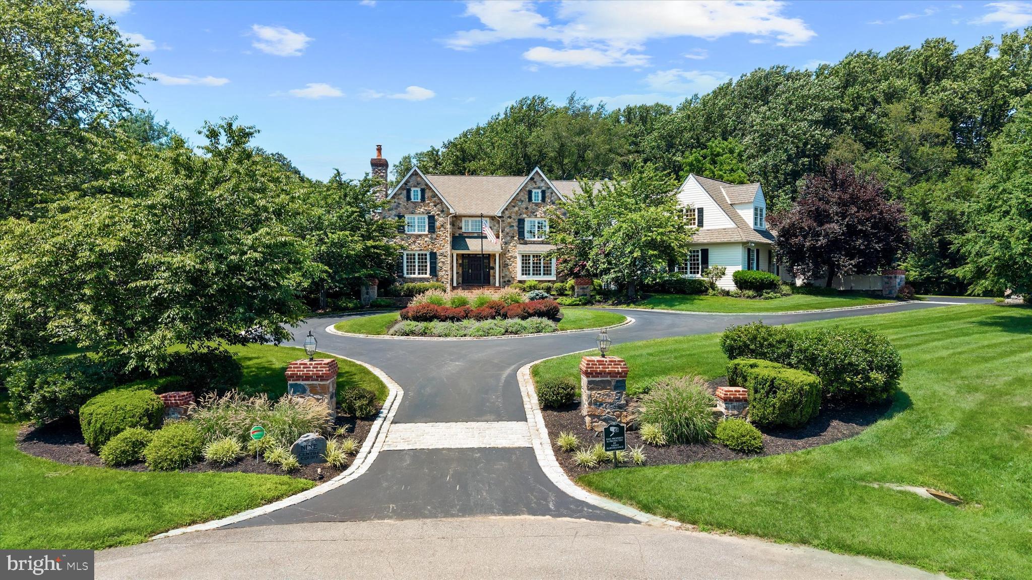 Welcome to this custom estate home in the sought-after, walkable community of Centreville Reserve, located in Centerville, DE. Designed by Hillcrest and Associates and built by Thompson Homes, this 5-bedroom, 4-full-bath, and 2-half-bath residence sits on an extremely private 2.55-acre cul-de-sac homesite. The property features timeless architecture, refined finishes, and true resort-style living, beginning with an inviting circular driveway and a grand two-story foyer. The main level includes formal dining and living rooms, a dedicated office with cherry built-ins, and a custom walk-in wine room. The dramatic two-story family room is highlighted by Gothic trusses, a stone fireplace, and a rear wall of glass. The gourmet kitchen is equipped with Paradise Kitchen cabinetry, a 9-foot leathered granite island with seating for six, and premium appliances from Sub-Zero, Bosch, and Jenn-Air double ovens, walk-in pantry., and a coffee/cappuccino station. For seamless indoor-outdoor living, the breakfast room leads to a covered seating porch and a separate screened porch that opens to an expansive hardscape area. Functional main-floor features include a convenient second powder room, a back staircase, and an oversized 3-car finished garage with over 1,000 square feet of space, with a workbench, sink, and charging station. On the upper level, the primary suite offers a sitting area with a gas fireplace, his-and-her walk-in closets with organizers, and a luxurious bath with a steam shower, heated floors, and a soaking tub. The additional bedrooms are well-appointed, including a vast third bedroom that serves as a flexible "princess suite" or in-law quarters with its own office and sitting room. Bedrooms two, four, and five feature remodeled Jack-and-Jill bathrooms and ample closet space. The expansive lower level is designed for ultimate entertainment, featuring a 10-foot two-tier wet bar, a gaming area, a billiards room, and a home gym. This level also includes a daylit recreation room with glass doors leading to a private patio and firepit, along with a fully renovated bath servicing the pool area. Outside, the resort experience continues with a custom saltwater heated pool featuring a wading shelf, fountains, and a spa with a waterfall, stone retaining walls and pool surround. The grounds also offer an open-air cabana with a granite bar and gas grill, plus a large blacktop driveway designed for basketball, pickleball, and street hockey. System features Dual zone High efficiency HVAC & Hot water systems, whole house Humidifier, Honeywell fresh air ventilation system, 400 amp of electric service w/ backup generator, well with water softener, smart home automation, whole house audio.  All located just minutes from Centerville Village and top-rated private schools, this estate offers an unparalleled combination of scale, sophistication, and lifestyle in one of Delawares most prestigious neighborhoods
