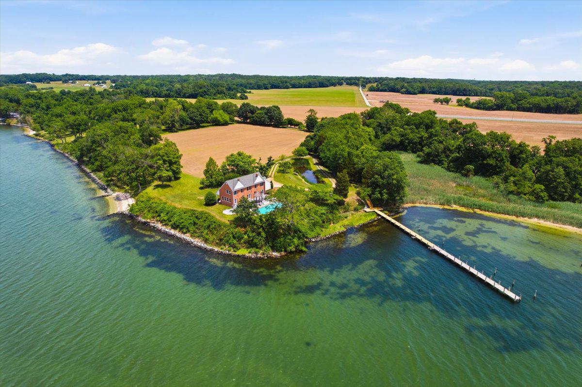 ONCE IN A LIFETIME setting on the Patuxent River at Preston on the Patuxent. This home was designed by Don Hawkins, an award-winning Georgetown Wash DC architect. It was built in 1984 to comply with and complement the National Register's 'Preston on the Patuxent' historic residence and shares the historic site. Perched on an elevated point of land with incredible southerly vistas of the Patuxent River, this site delivers. Natural light pours into the heart of the home. The kitchen is beautifully arranged, and you can cook to your heart's content while watching wildlife, boats, tending a fire. You'll love the extensive Trex decking with ipe and wire railings, extensive hardscape surrounding the inground pool. There is a separate entrance to the 1BR/1BA guest apartment above the garage, also a mostly finished basement with dual office spaces or hobby spaces, and a great home gym space as well.