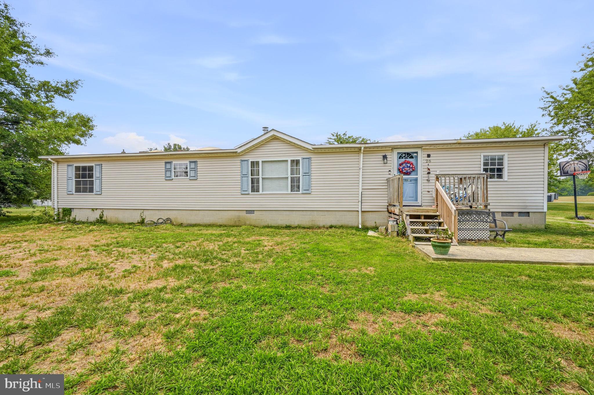 Welcome to 26 Pardoners Tale Lane, Felton, DE, where peaceful country living meets endless outdoor possibilities. Situated on a spacious lot surrounded by mature trees, this well-maintained manufactured home offers privacy, open green space, and plenty of room to enjoy the outdoors. A welcoming front porch provides the perfect place to relax with your morning coffee or unwind in the evening. The expansive yard offers countless opportunities for gardening, entertaining, outdoor recreation, or future improvements. A fenced backyard creates an ideal space for pets or play, while the detached storage shed provides additional room for tools, lawn equipment, or seasonal storage. The long driveway offers ample off-street parking for multiple vehicles, trailers, or recreational equipment. Mature landscaping and established shade trees add beauty and character to the property while creating a peaceful setting. Conveniently located just minutes from Route 13, Dover, local shopping, restaurants, schools, and Delaware beaches, this home combines the tranquility of country living with easy access to everyday conveniences. Whether you're looking for your first home, downsizing, or simply searching for extra outdoor space to make your own, 26 Pardoners Tale Lane offers exceptional potential in a desirable Felton location. Schedule your private showing today!