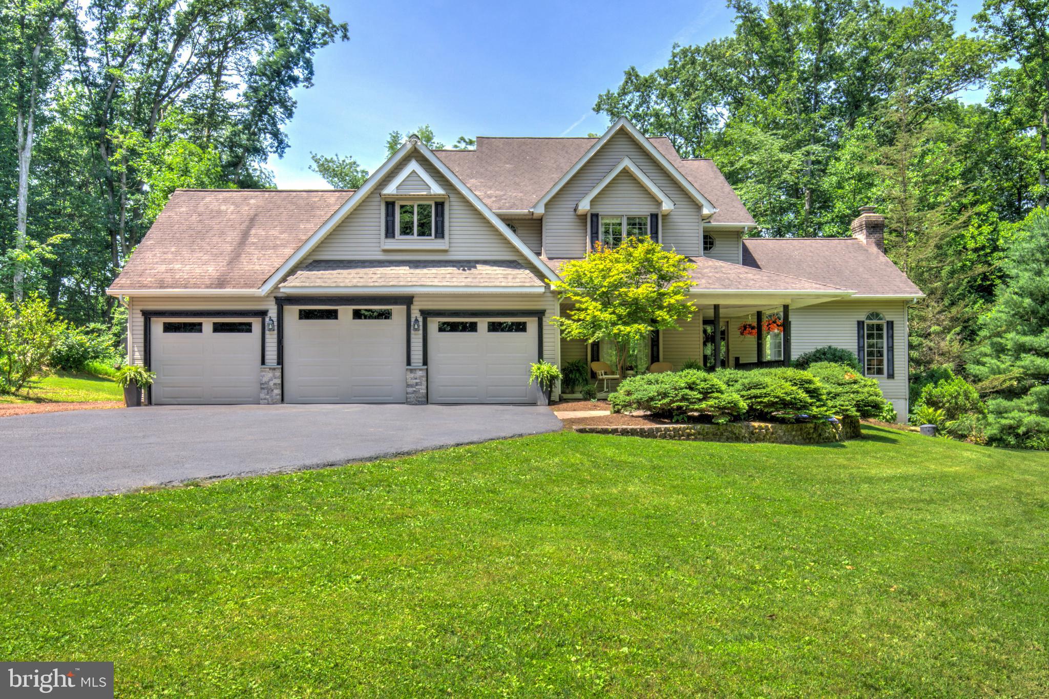 A stamped concrete walkway welcome you to this remarkable home with outstanding curb appeal and features. Situated on over 3 acres of beautifully sequestered grounds and landscape bordered by a trickling brook. This is the place to make lasting memories with its gorgeous home featuring an open floor plan, floor to ceiling windows overlooking the private patio and splashing waterfall. The stone living room floorplan anchors the well lit living room. A grand staircase opens up to the second floor and hallways. This home's modern kitchen invites the most discriminating chef to apply their skills with the 5 burner gas stove, double ovens, and stainless steel appliances. A drink cooler keeps refreshments ready in the coffee bar area. Breakfast nooks, granite countertops and bars make this kitchen area a true gathering experience! Upstairs, the primary bedroom suite offers numerous amazing features including Bluetooth speakers in the luxurious double shower, spacious sinks and a fireplace which are set apart from the private toilet area. The vaulted 10x20' walk in closet will leave you speechless, in addition to the dressing area. Down the hallway, 2 more bedrooms each offer walk in closets and one with a floating loft play area. The lower level area is built out with another lovely bedroom, a great room and game room area. The home is equipped with a full water treatment and UV light system and a radon system. The outdoors is a haven for gardening and bird watching. A unique tree trunk picnic area and custom tree house is an invitation to explore the wooded rear of the property. Wildlife abounds in this private, tucked away homesite at the end of a meandering driveway. Don't miss this amazing property only minutes from Rts 240, 30, and 322 corridors.