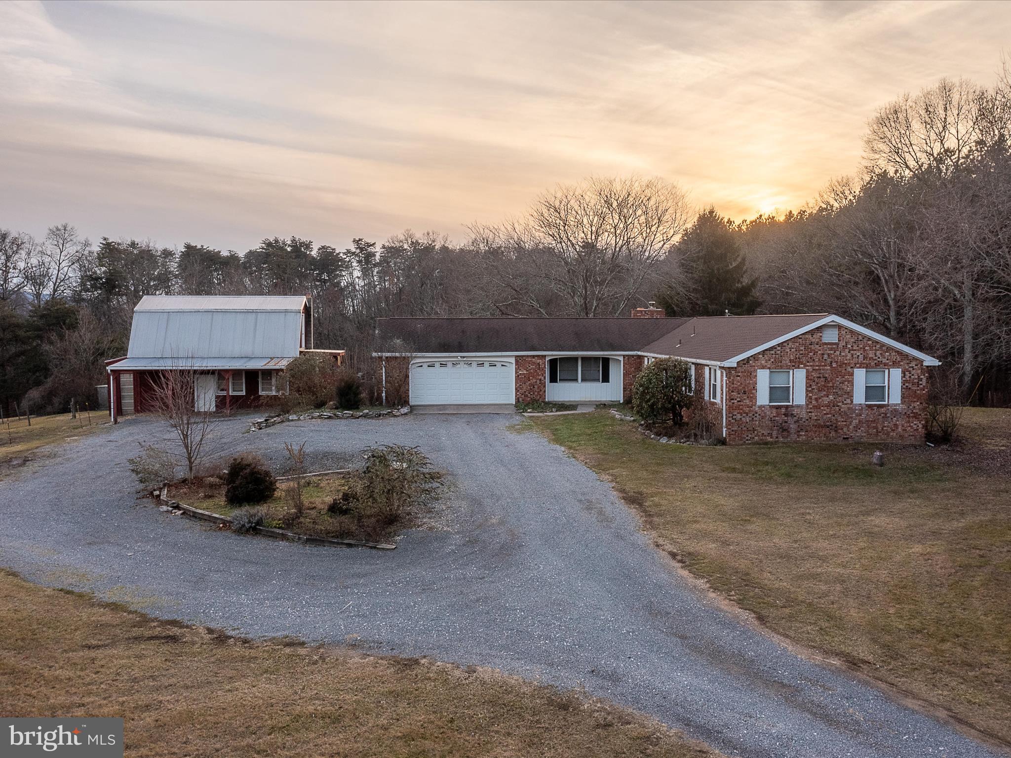 6.7923 UNRESTRICTED ACRES located along Rt. 9 (Martinsburg Road) just 7 miles from downtown Berkeley Springs.    Room for animals and or your own in home business location.   Home features:  4 Bedrooms, 2 full Baths, Eat in Kitchen with bar, Living Room/Dining Area with fireplace w insert to keep you nice and warm on cold days, Family Room, partial Basement with laundry hookup.   Outside you are sure to enjoy the attached 2 car garage, 30x30 rear deck, partially fenced yard with several fruit trees.  Check out the detached building with an upper level (previously used to hold tanning beds).  Plus another building that was used as a barn.    Come look at the possibilities!