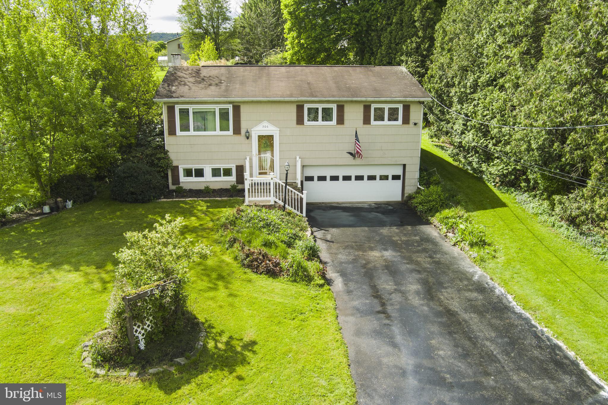 Tucked gracefully within the Fairbrook neighborhood, this lovingly maintained home sits among lush landscaping, mature trees & a truly unique setting. With 3 parcels totaling 1.04 acres the home on .37 acres plus 2 additional parcels across the street (.34 and .33 acres) this property offers rare breathing room & a sense of space that’s hard to find.  Step inside to a light filled living room featuring beautiful hardwood flooring that flows seamlessly into the dining room. Sliding glass doors open to the covered rear patio, where you can unwind while overlooking the tranquil, private backyard.  The updated kitchen blends timeless style with everyday function, offering solid wood cabinetry, granite countertops, ceramic tile flooring & included stainless appliances.  Down the hall, you’ll find a remodeled full bath with tile flooring, an oversized vanity & a tub with a beautifully tiled shower surround. Three nicely appointed bedrooms all with hardwood flooring & ceiling fans, complete the main level.  The partially finished lower level adds even more versatility with a 10x27 family room with a cozy wood stove to help supplement heating costs, half bath, dedicated laundry room area included washer & dryer & an integral 2 car garage. Additional amenities include mini split ductless unit, electric ceiling cable heat & close proximity to Fairbrook Park.  Located less than 8 miles from State College & 9.5 miles from Beaver Stadium/Penn State University, this property offers the perfect blend of peaceful living & convenient access to town.  A rare opportunity where space, serenity, and a true sense of home come together the moment you arrive.
