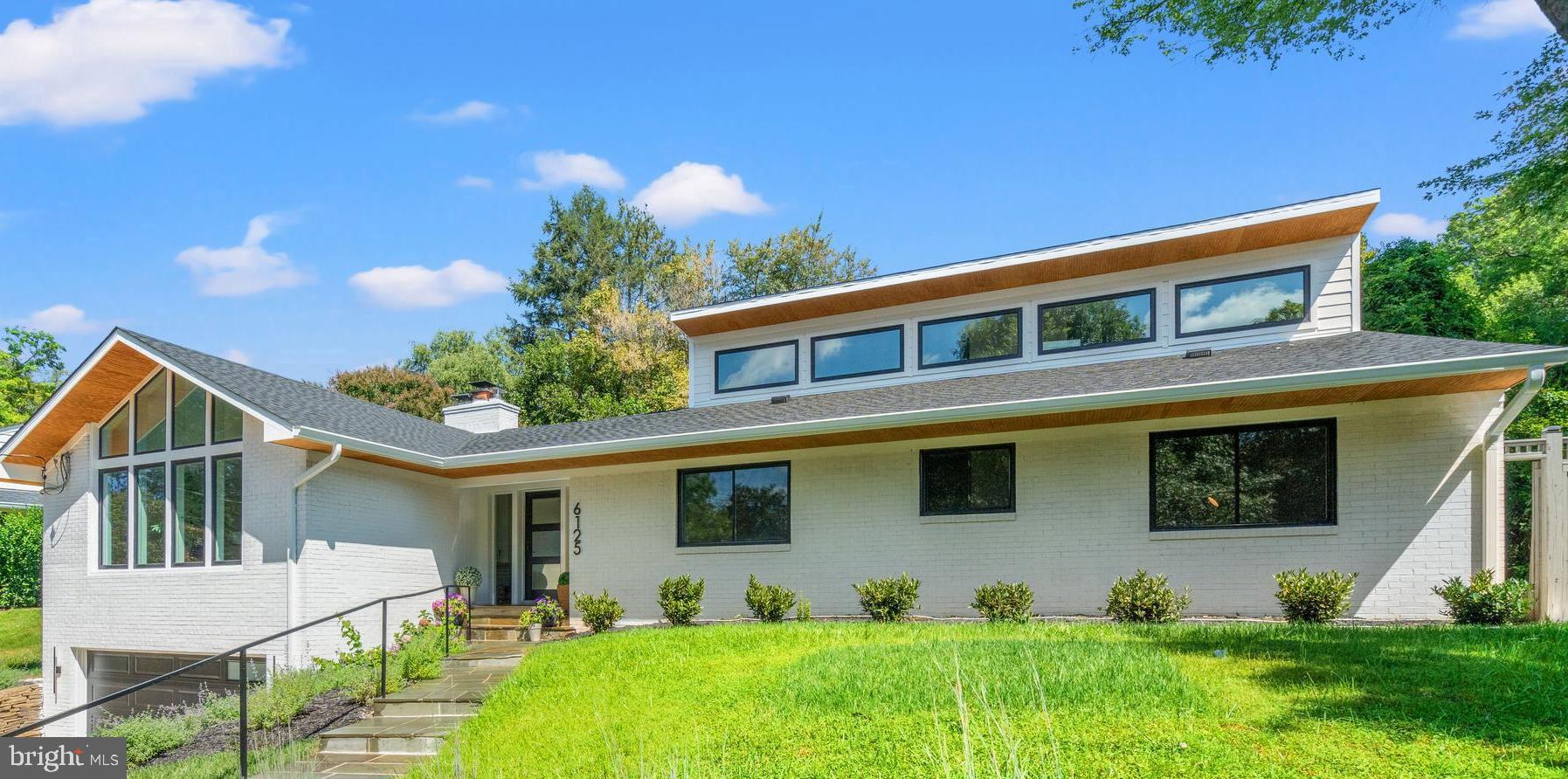 Prepared to be "wowed" when you lay your eyes upon this stunning, one-of-a-kind, renovation and expansion of a mid-century modern retreat in the sought-after Fort Sumner neighborhood of Bethesda. Welcome to the new home you didn’t know you would be falling in love with!  Dogwood Restoration has created the perfect blend of California contemporary with a nod to mid-century design in this unique show piece with 5,000 square feet of luxuriously finished space. Modern elegance and timeless details abound in this six bedroom, four full and one-half bathroom home, ideally situated on a beautifully landscaped quarter-acre lot that is pool-ready.
From the moment you arrive, this striking residence impresses with clean architectural lines, soaring ceilings, and an open, light-filled floor plan designed for both everyday living and sophisticated entertaining. Thoughtfully reimagined with premium finishes and high-end systems throughout, no detail has been overlooked.
Experience a warm welcome in to the main level through a custom front door and dramatic entry hall running the full width of the house, with vaulted ceilings, a stunning center chandelier, coat closet and half bathroom with custom wall covering. The expansive living and dining areas with walls of windows, sleek wide-plank hardwood floors and incredible cathedral ceilings are anchored by a beautiful stone fireplace. The designer chef’s kitchen is filled with custom cabinetry, Calcutta gold quartz countertops, top-of-the-line Thermador appliances, including two dishwashers, a separate pantry, and a generously sized island with prep sink and seating for four.  A beautiful wine bar with storage and curved ceiling detail and double glass doors to the rear flagstone patio complete the living section of this level. 
The bedroom wing of the main level includes a sumptuous primary suite, with expansive walk-in closet and incredible spa-like full bathroom with glass shower, separate soaking tub, dual vanities and heated marble floors.  Two additional secondary bedrooms, a stunning full hall bathroom and convenient main level laundry room complete the main floor.
Retreat upstairs to a fabulous upper-level family room and private guest bedroom with a full en-suite bathroom. The expansive lower level includes a generous recreation room, custom mudroom, a wine bar and game room, two huge bedrooms, each with double closets, a stunning full bathroom, extra storage and access to the home’s oversized two car garage. 
Enjoy outdoor living on the expansive, fully fenced, pool-sized lot with a flagstone patio, mature landscaping and beautiful stone retaining wall -- perfect for entertaining or relaxing in a peaceful setting. Located just minutes from the Capital Crescent Trail, downtown Bethesda, and top-rated schools, this home offers a rare blend of design, comfort, and location.  Welcome home!