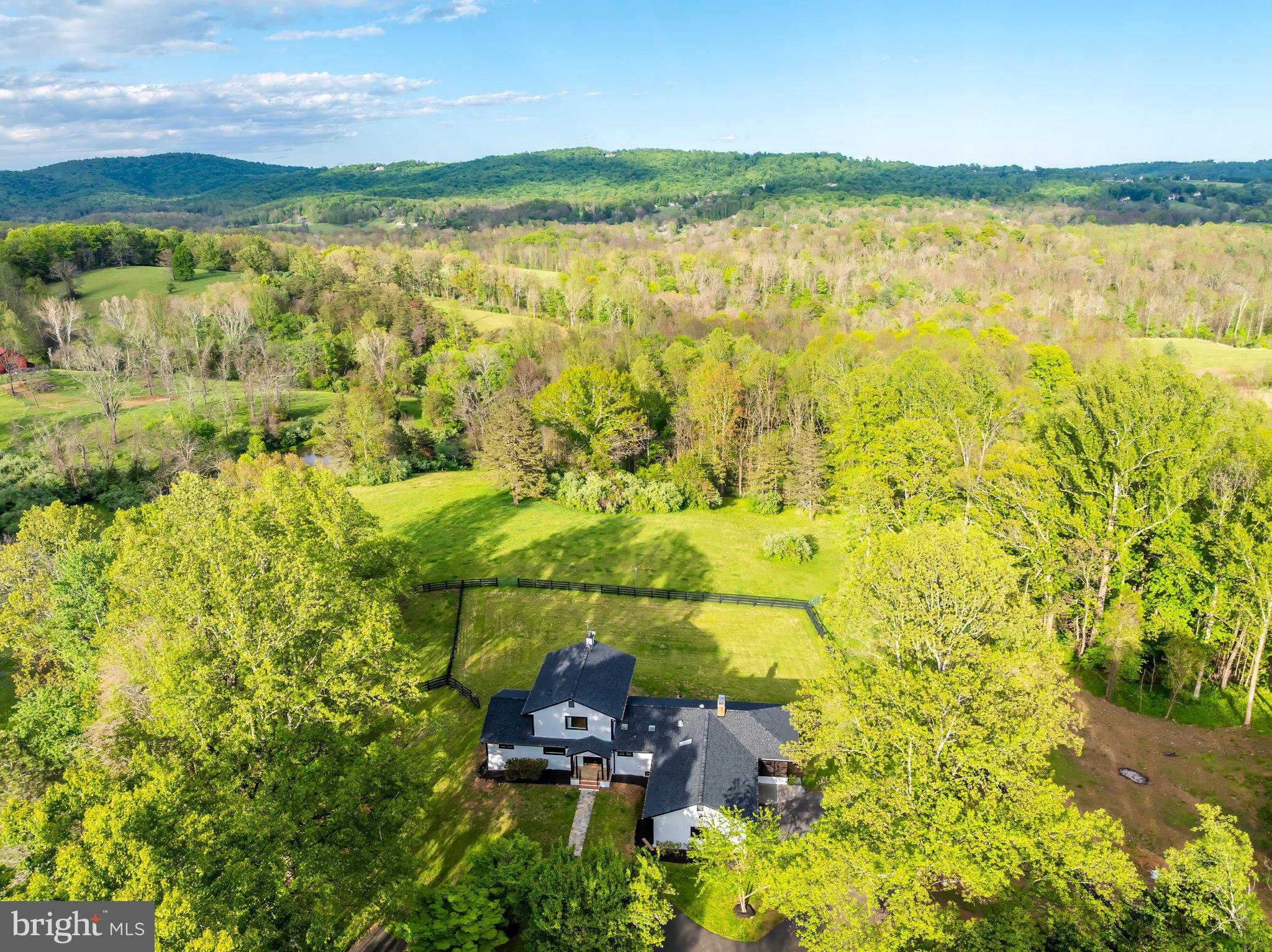 OPEN HOUSE SUNDAY 6-28-2026 FROM 1PM-4PM. REDUCED $100,000!Nestled in the serene landscapes of Marshall, VA, this exquisite contemporary residence, set on an expansive 8.3-acre lot, offers a luxurious lifestyle defined by elegance and tranquility. The property has undergone a major renovation in 2026, ensuring modern sophistication while preserving its timeless charm. The exterior features a stunning wood siding façade, harmonizing beautifully with the natural surroundings. A circular paved driveway leads to an oversized attached garage, providing ample parking for guests. The property boasts a dedicated barn/stable, catering to equestrian enthusiasts, while the lush, private grounds are bordered by trees and open space, creating a secluded retreat. Step outside to revel in breathtaking panoramic views of the mountains and valleys, where every sunrise and sunset paints a picturesque backdrop. The meticulously landscaped rear yard invites outdoor gatherings, while the surrounding wooded areas offer a sense of peace and privacy. Inside, the home features four spacious bedrooms and three and a half luxurious bathrooms, complemented by two elegant wood-burning fireplaces that add warmth and character. The fully finished daylight basement provides additional living space, perfect for entertaining or relaxation. This property is not just a home; it's a lifestyle, offering the perfect blend of luxury, nature, and equestrian amenities. Experience the ultimate in refined living, where every detail has been thoughtfully curated for comfort and style.