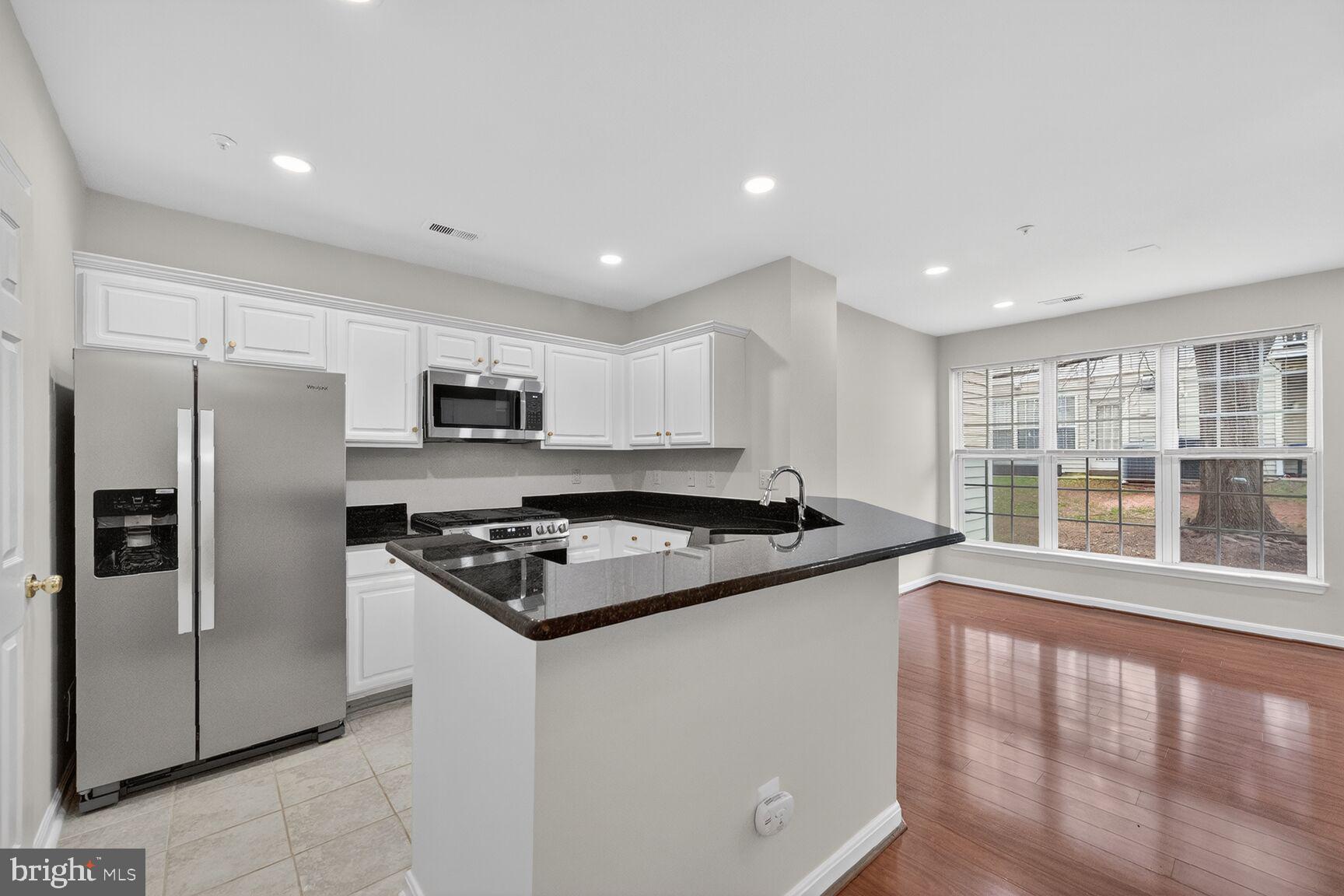 Step into a masterpiece of modern design in the sought-after Dominion Station community. This stunning home has been transformed with premium 2026 upgrades, offering a truly turnkey experience. The main level is bathed in light from newly installed recessed lighting and features gleaming hardwood floors that extend throughout the entire home. The chef-inspired kitchen boasts granite countertops and brand-new stainless steel appliances. All three bathrooms were fully reimagined in 2026. The two upstairs full baths feature custom tile showers and flooring with rainfall shower heads and hand wands, while the primary and main-level half bath showcase elegant new vanities. Even the laundry room has been elevated with custom tiling to match the bathrooms. Beyond your front door, enjoy amenities including a pool and walking trails. Perfectly positioned for commuters, you are minutes from the Silver Line Metro, Dulles Airport, and the Dulles Tech Corridor, with premier shopping and dining at One Loudoun and Dulles Town Center just moments away.