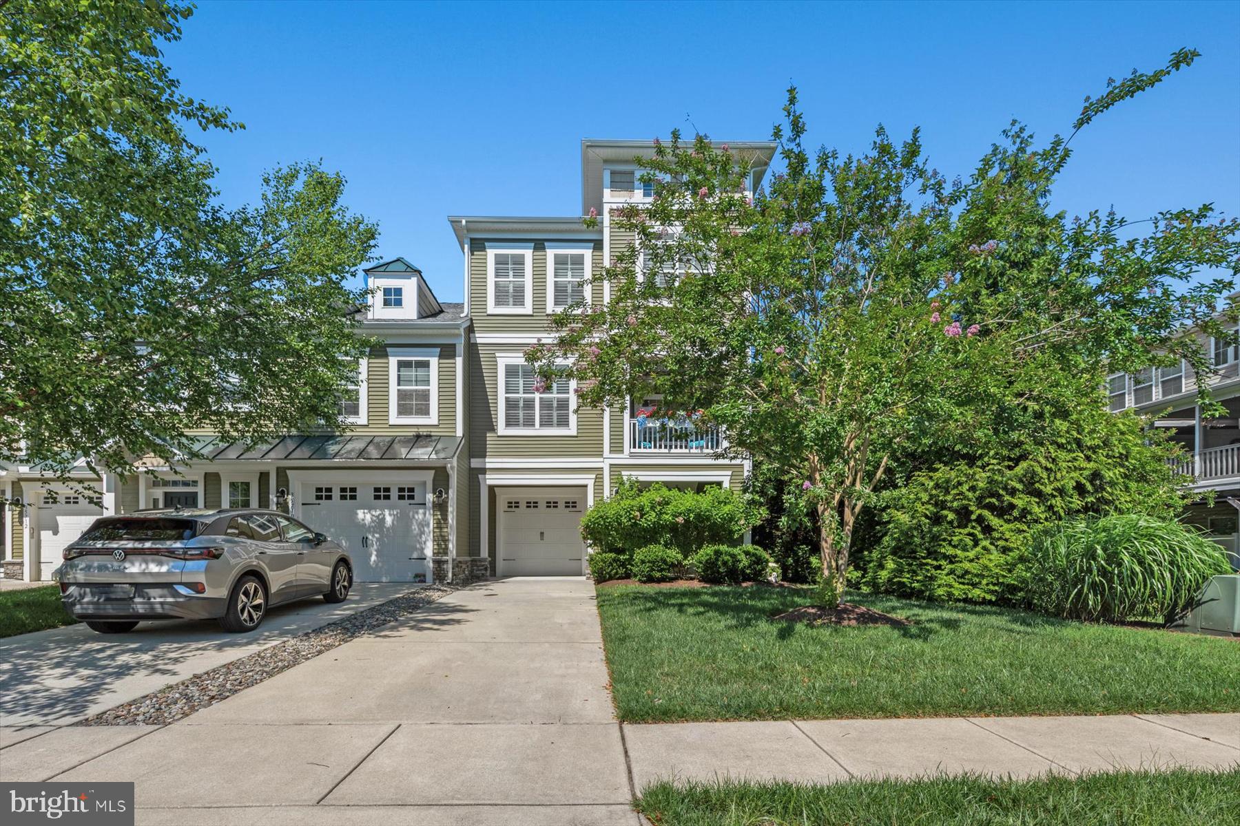 Discover refined coastal living in this 4‑bedroom end‑unit townhome, perfectly positioned along a mature, tree‑lined lot that provides exceptional privacy and a serene natural backdrop. Spanning three levels of luxury, this residence offers thoughtful design, flexible living spaces, and premium finishes throughout. The first floor features a true in‑law suite, complete with its own living area, spacious bedroom, full bath, and a private patio—ideal for guests, extended family, or a quiet retreat. Ascending to the main level, you’re welcomed into an open, light‑filled living space anchored by a gourmet kitchen with an extra‑long island perfect for entertaining. The living room is both elegant and inviting, featuring a cozy fireplace and a screened‑in porch dressed with beautiful draperies for added privacy. A generous dining area sits just off the kitchen and includes a charming front balcony overlooking the community. The third floor is home to a sprawling primary suite, complete with a spa‑inspired bath featuring a soaking tub and separate walk‑in shower. Two additional bedrooms, a stylish hall bath, and a convenient laundry room complete the upper level. For ultimate ease, the home includes a three‑stop elevator, making it effortless to bring groceries to the kitchen or enjoy stair‑free access to every floor.  The home is being sold practically turnkey with all furniture included, artwork, and most accessory items. Located in the sought‑after, resort‑style community of Sawgrass, residents enjoy proximity to the beaches of Southern Delaware or take a short stroll and soak in the sights of the Rehoboth Bay. The community boasts an impressive array of amenities including multiple pools and clubhouses, tennis courts, and a fitness center. This is coastal living at its finest—private, polished, and perfectly situated. Professional photos and floor plan coming on Thursday.