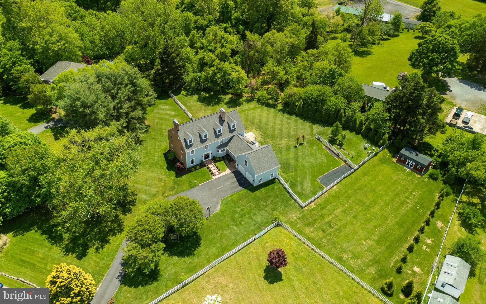 Welcome to a truly special property in the sought-after Tameron Hall community, where privacy, space, and lifestyle come together on 3.6 picturesque acres in Harwood. One of only three pasture-zoned properties in the neighborhood that allows horses, this exceptional Colonial-style home offers a rare opportunity to enjoy a peaceful setting while remaining just minutes from Edgewater, Annapolis, and Crofton. Surrounded by open fields, mature landscaping, and breathtaking sunset views, the property is a private oasis complete with fenced pasture space, thriving berry bushes and fruit trees, a vegetable garden, strawberry patch, mint garden, and even equipment for beekeeping enthusiasts. A wraparound deck and patio provide the perfect setting for outdoor entertaining or quiet evenings overlooking the expansive backyard and rolling scenery.

Originally renovated in 2021, this impressive residence blends timeless charm with modern comfort across more than 6,500 square feet of thoughtfully designed living space. Inside, vaulted and cathedral ceilings, abundant natural light, and two wood-burning fireplaces create a warm and inviting atmosphere. The spacious layout is ideal for both everyday living and entertaining, featuring four bedrooms, five bathrooms, and multiple flexible living spaces throughout four finished levels.

The expansive living areas seamlessly connect to picturesque views of lush trees, gardens, and open pastures, while the heated walkout lower level offers incredible versatility with a home theater featuring projector, screen, AV system, and theater seating, along with a fitness area, recreation space, and extensive storage. A unique attic suite adds even more flexibility, offering a variety of potential uses to suit changing needs over time.

Thoughtful updates and improvements provide peace of mind and energy efficiency throughout. Major upgrades include a 15.54kW solar system with 44 panels, new roof and siding, updated HVAC systems, rebuilt brick entryway, new water softener and well systems, EV charging outlet, Amish-built shed, extensive insulation and energy-efficiency enhancements, fresh interior paint, professional landscaping, and meticulous ongoing maintenance.

Set within the serene and highly desirable Tameron Hall community and located in the South River school district, this beautifully maintained property offers an exceptional combination of space, versatility, modern efficiency, and natural beauty in a prime Anne Arundel County location.