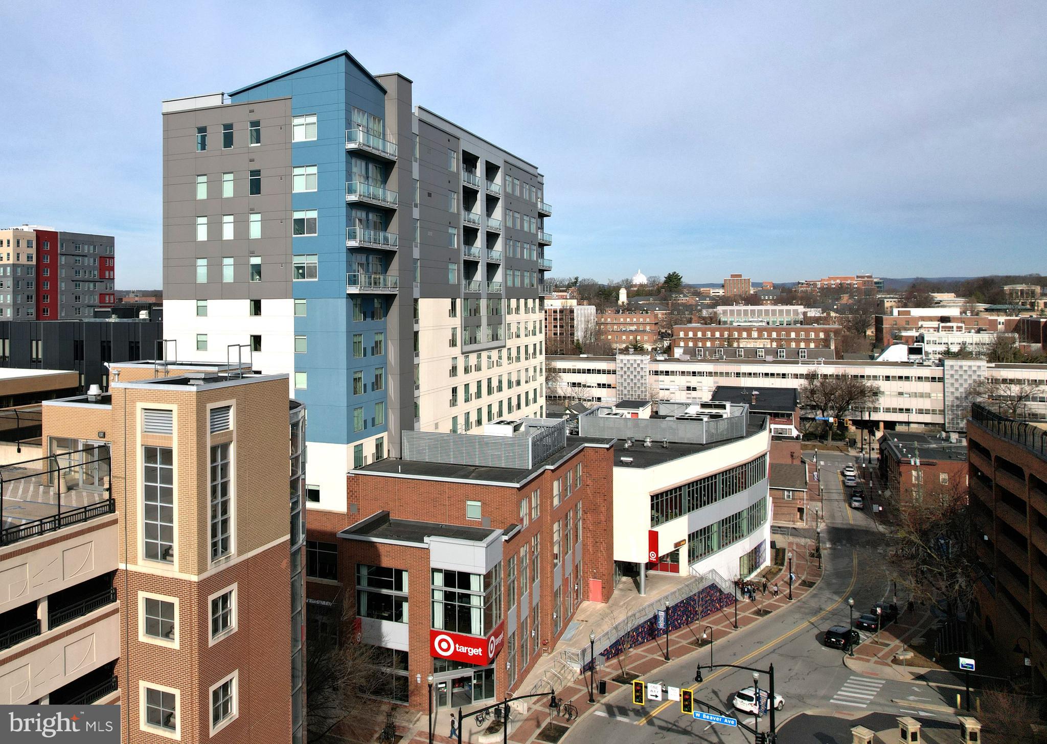 Welcome to exclusive, luxury living in this stylish, lower penthouse condo at the Fraser Centre in the heart of downtown State College.  Capturing panoramic sights of downtown, Penn State's campus, and the Tussey Mountain range from the eleventh floor, you'll be captivated by the expansive views.  Enter into this modern, elegantly designed  home taking in the twelve-foot ceilings and abundant natural light from the floor-to-ceiling windows in the open concept layout.  Combining contemporary lines with rich textures the spacious, luxury kitchen features an expansive island with plentiful seating, high-quality and extra tall modern cabinetry, Bosch stainless steel appliances, and quartz countertops, while the great room boasts a custom built-in bookshelf/TV cabinet with LED lighting and access to the large balcony for outdoor living, breathtaking sunsets, and stargazing.  The well-appointed bathrooms feature tiled showers with hand-held sprayers and custom glass doors, high-end cabinetry with quartz countertops, and Robern lighted medicine cabinets.  Additional features include electric roller shades, plentiful recessed and undercabinet lighting, keyless entry, new carpet in the bedrooms, and fresh paint throughout.  Enjoy fresh air from the glass walled balcony and relish the beautiful west-facing views overlooking State College and the mountains of Rothrock State Forest in Happy Valley provide gorgeous afternoon sun and magnificent sunsets.  This distinctive building provides residents with a rooftop patio for outdoor entertaining, relaxing and taking in amazing views, as well as underground reserved parking and secure bike storage, a secure climate controlled storage locker, and access to the gym and morning breakfast at attached Hyatt Place.  Also, within other parts of the building for your convenience is a Target, the Federal Taphouse, Starbucks, and Planet Fitness.  A prime location in downtown State College, you're  steps from an abundance of restaurants, entertainment venues, coffee shops, and Penn State's campus.  Whether you're looking for a discerning, upscale metropolitan lifestyle, desire the perfect place to visit and enjoy Happy Valley, or want an exceptional space in which to entertain, this seldom available opportunity is waiting for you!