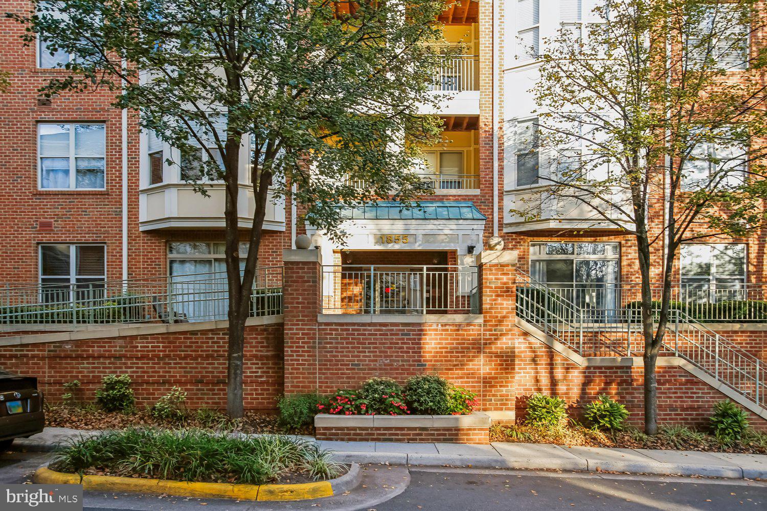 A part of Reston Town Center,  living in this sophisticated luxury condominium will put you in the middle of all the action.  An open floor plan with high-end painting,  window treatments, & new LVP flooring.  A bright white kitchen with lots of cabinets, marble counters, under cabinet lighting, & gas cooking has a laundry room nicely tucked away.  A generous dining area has crown molding, chair railing, & a spectacular light fixture.  The living room with an updated gas fireplace, large windows & a ceiling fan opens to a darling patio with large planters that convey.  The primary bedroom is spacious with windows on two walls, ceiling fan, & an organized walk-in closet.  The primary bath has a double sink vanity with marble counters, a steam shower, & pendant lighting.  The 2nd bedroom is well appointed with a ceiling fan, an organized walk-in closet, & private access to the 2nd bathroom.  The unit is located near the side exit for quick access to the outdoors where the community is very pet friendly.  Underground parking space & storage for the unit will be conveyed.  You are steps away from the community pool,  clubhouse, office area, library, , gym, & showers leading to the pool area.  Less than a mile from the Reston Metro.  Easy access and easy living.  The best of Reston!