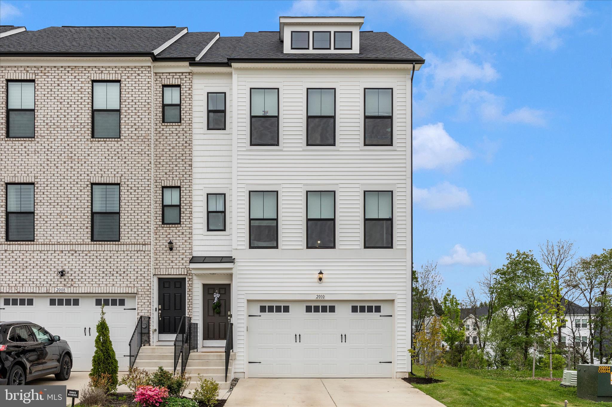 NEW PRICE ADJUSTMENT! Welcome home to this nearly new, 2-year-old end-unit townhouse that perfectly blends comfort, style, and low-maintenance living. With a spacious 2-car garage and an impressive 8' bump-out on every level, this home offers exceptional space and an open, airy feel throughout. The heart of the home is the beautifully upgraded kitchen, featuring KitchenAid appliances, a wall oven, cooktop, quartz countertops, large pantry, upgraded cabinetry, and a large island—perfect for entertaining. Just off the kitchen, step onto your private balcony and unwind while taking in peaceful views of the creek—an ideal spot for morning coffee or evening relaxation while watching deer pass by. The adjoining dining area flows seamlessly for gatherings, while the light-filled living room showcases stunning mountain views. Those same scenic views continue from the front bedrooms, creating a serene and inviting atmosphere throughout. Upstairs, the spacious primary suite is a true retreat, highlighted by a tray ceiling and a luxurious Roman bath with double shower heads and dual sinks. The hall bathroom also features dual sinks, offering added convenience. A dedicated laundry room with built-ins makes everyday living even easier.  Additional upgrades include enhanced kitchen and bathroom cabinetry, upgraded flooring throughout, upgraded light fixtures, a triple dormer window, and an EV charger in the garage.  Enjoy the ease of an HOA that takes care of lawn mowing and sidewalk snow removal, giving you more time to relax and enjoy your surroundings. For added recreation, a community pool is available for an additional fee.  This home truly offers the perfect combination of thoughtful upgrades, comfort, and scenic beauty—all in a low-maintenance lifestyle.