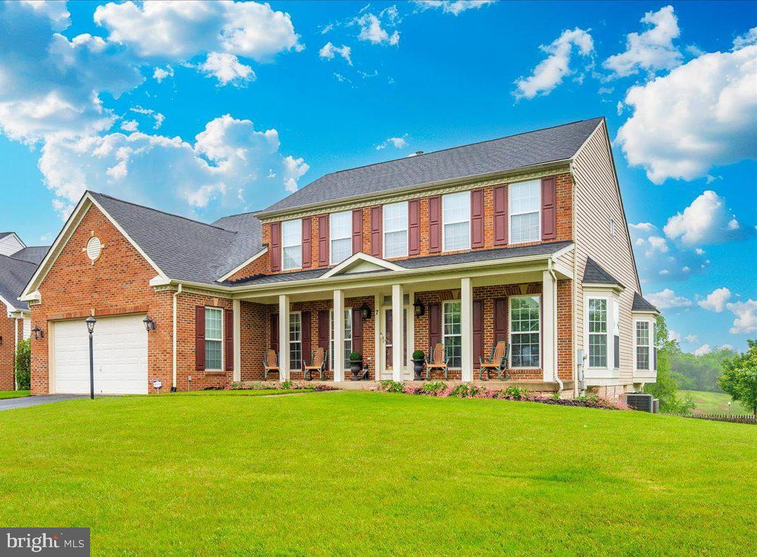 Stunning brick-front Colonial on a quiet cul-de-sac in highly sought-after Galyn Manor, now featuring a recent price improvement just in time for the spring market! 

Meticulously maintained by the original owner and recently refreshed with previous wallpaper removed and fresh paint throughout most of the home, this beautifully upgraded home offers elegant living spaces, soaring ceilings, and exceptional indoor-outdoor entertaining.

A welcoming covered front porch leads into the impressive two-story foyer with gleaming hardwood floors. The heart of the home is the chef's kitchen, featuring cherry cabinetry, new granite countertops, gas cooking, double oven, double sink, breakfast bar, and new dishwasher. The spacious eat-in area opens to an oversized screened deck with stunning knotty pine cathedral ceiling, perfect for entertaining or relaxing.
The two-story great room creates a dramatic yet comfortable gathering space. The main-level primary suite features two walk-in closets and a spa-like bath with dual vanities, soaking tub, and walk-in shower. The main level also includes laundry, powder room, formal dining room with bump-out, and formal living room.
Upstairs offers a second primary suite with private bath, plus two additional bedrooms and a hall bath.
The finished lower level is ideal for guests or multigenerational living with a kitchenette, hobby room, full bath, and a spacious recreation room with walkout to the patio.
Additional highlights include central vacuum, Hunter blinds, and enclosed storage under the deck with concrete flooring. Conveniently located near schools, shopping, restaurants, and the MARC train, offering an excellent commuter location.
Note-Some listing photos are virtually staged