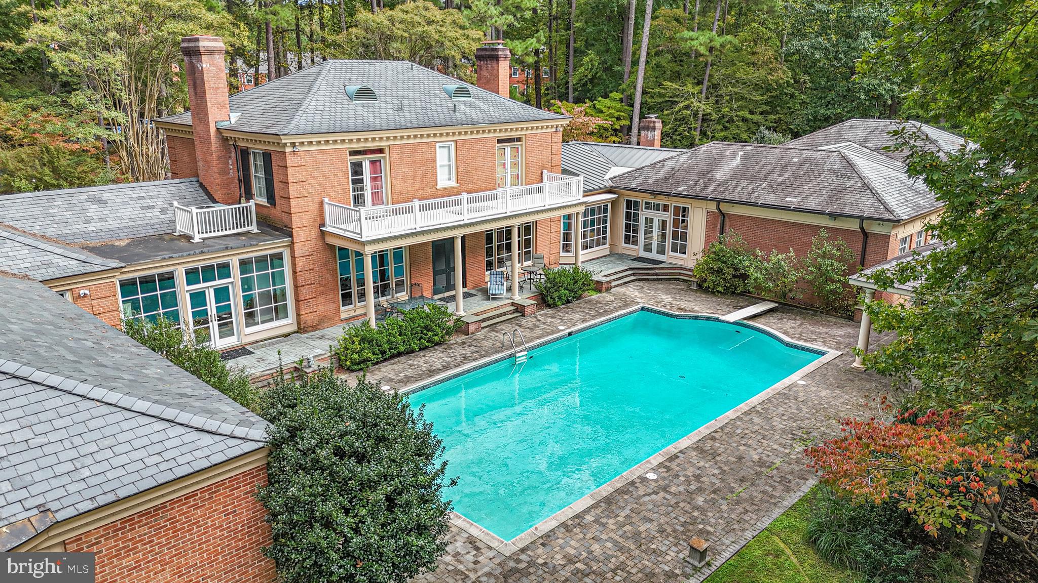Extraordinary 7,500 sf all-brick Georgian on 5.06 acres w/exceptional quality, beautifully designed interiors & private outdoor living spaces. The main level offers: two primary suites w/fireplaces, formal dining room, formal living room w/fireplace, family room w/fireplace, rec room, laundry room, full bath, & powder room. Luxury primary suite wing features en suite bath with infinity tub, tile shower, two water closets, flex space, laundry, & amazing custom walk-in closet w/cedar closet. Eat-in kitchen features Sub-Zeros, cooktop, double ovens, warming drawer, & walk-in pantry. Upstairs offers three bedrooms, two with access to the exterior balcony, and two Jack and Jill baths. The exterior includes mature landscaping, gunite saltwater pool, pergola, off-street parking for 12+, four-car garage w/walk-up attic, a generator, and mail delivery to your front door. Prime location in the City of Williamsburg, less than one mile from The College of William & Mary, and Colonial Williamsburg.