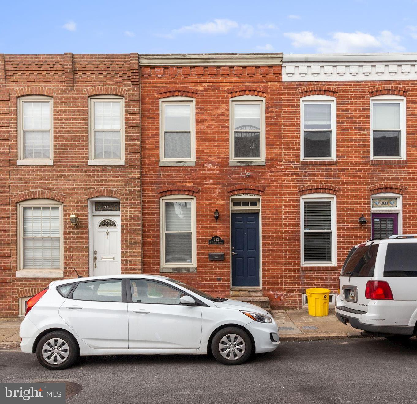 Situated in the HEART OF CANTON, this  efficient rowhome offers EVERYTHING you need for a convenient urban lifestyle and nothing that you don't!  Renovated tactfully with efficient use of space in mind, utilizing architectural components such as "floating tread" staircases and a 2-story skylight column to optimize space and light! Offering a surprisingly large Kitchen w/ ample cabinet space, Dining Area w/ gas fireplace, a huge Full Bath w. dual sink vanity plus a fully finished Lower Level that is perfect for your specific needs:  Home Office/Study, Yoga Room, storage.  Easy parking in the rear parking pad; panoramic CityScape views from the bilevel balcony and roof deck!