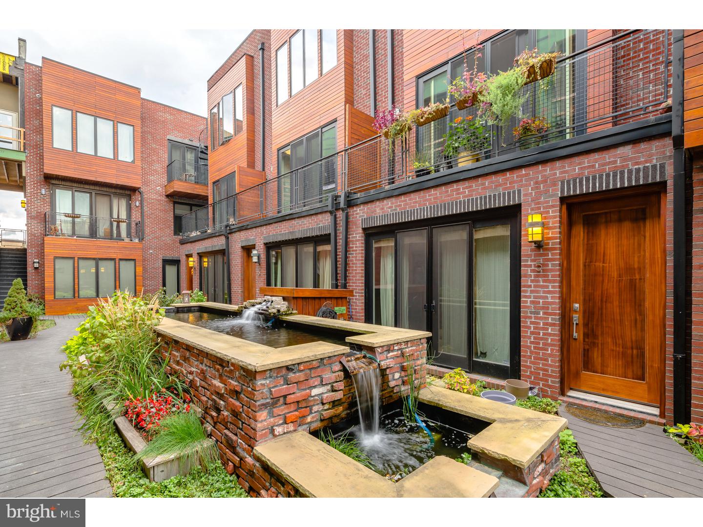 This spectacular Ice House phase 1, 2 bedroom, bi-level, 1.5 bath unit offers a large Private Green Roof and one car garage parking! Interior features include field finished oak hardwood floors throughout, recessed lights in LR, stunning floating steel stairs, large casement windows, custom kitchen with Energy Star stainless appliances, Quartz Counter tops and a large island with seating, flat panel bamboo cabinetry, stainless under mount sink with goose neck chef's faucet, pendant lighting, and stunning back splash. There is a balcony with tiled threshold overlooking the Koi pond in the living room. There is a convenient half bath on the 1st floor, along with a  front loaded full size washer and dryer on the 2nd floor. The 2nd floor has 2 spacious sun filled bedrooms and ample closet space. The large bath has a dual floating vanity, basin sink, and a soaking tub with shower combination beautifully tiled. Access to the large private Green Roof is from the 2nd floor guest bedroom. The common grounds are equally impressive and include a common green roof, planters throughout and a deck level Koi pond maintained by the property's rain water recycling system. Other common spaces to enjoy are the Ball Park over look, roof deck with seating, outdoor kitchen, and a rooftop Dog Park and sun deck. Located in walking distance to everything. The Frankford Arts and Girard Ave corridors have tons to offer including cafes, shopping, fitness, restaurants, and galleries. Garage parking spaces are valued at 20K and this one is included with the price of the unit. Phase 3 has only two remaining 1 bedrooms. This phase 1 resale has 5 plus years remaining on the tax abatement. VA approved!