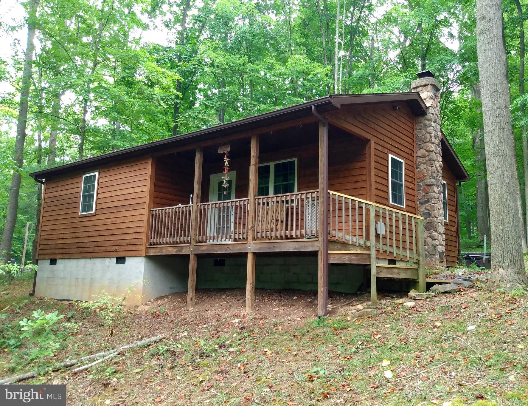 RIVER COUNTRY!!! Newer Cedar Cabin with 177 feet on the Sparkling Cacapon River. 2BR, 1BA, Complete kitchen, hickory cabinets, granite counter tops, full appliances. Washer and dryer, hardwood floors & cathedral ceiling, central heat/air along with a wood burning stove for the cool nights, stone chimney & hearth. Low - E windows and doors. This Cabin is located out of the flood zone but within view of the river so no flood insurance is required. Relaxing hot tub conveys. Everything is ready for you to enjoy, just bring your canoe and fishing pole. An outstanding value on your new waterfront getaway, so call today!