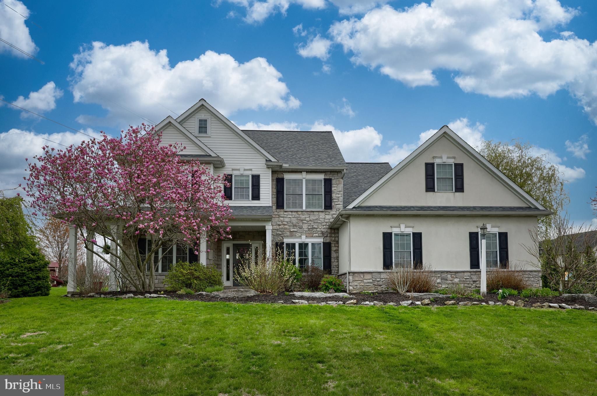 Welcome to this charming colonial farmhouse in the desirable Windy Hill neighborhood of West Lampeter Twp. Situated on a spacious .81-acre lot, this beautiful home features a classic wraparound porch, mature landscaping, and a large side yard—perfect for relaxing or entertaining. Step into your backyard oasis, complete with an in-ground pool and diving board—ideal for summer gatherings with friends and family or simply unwinding on warm afternoons. Inside, you'll find a versatile front study or home office and a cozy sitting room with gleaming hardwood floors. The heart of the home is the open-concept kitchen and family room, centered around a warm gas fireplace—a welcoming spot on chilly evenings. The kitchen offers a generous dining area and a large island with seating for four, perfect for meal prep, entertaining, or casual dining. Upstairs, the primary suite is a true retreat, featuring a jetted tub, separate shower, and spacious walk-in closet. Three additional bedrooms provide plenty of room, with two offering walk-in closets. There is also direct access to the attic area above the garage. The finished lower level includes a fifth bedroom and a family/game room—ideal for entertaining, relaxing, or hosting guests. The oversized two-car garage offers ample room for vehicles, storage, and all your tools and toys. All this just steps away from Windy Hill Park, combining comfort, space, and a wonderful community setting.