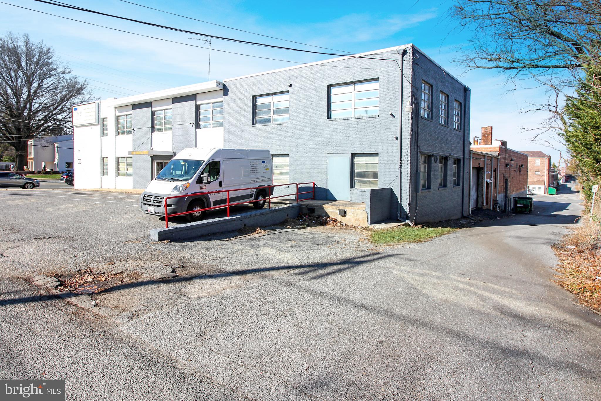 Solid brick corner street two level building with great visibility on Georgia Ave. Unit 2 is the bottom right quadrant approx. 2000 sqft of open space.  Two shared restrooms. Rent + NNN.  1 office space, 2 storage rooms and warehouse space.  Shared parking with other tenants for up to 8 cars. Dedicated loading docks. Public parking on the street and public metered parking 1.5 blocks away. Lot across the street is private and owner will not rent.
