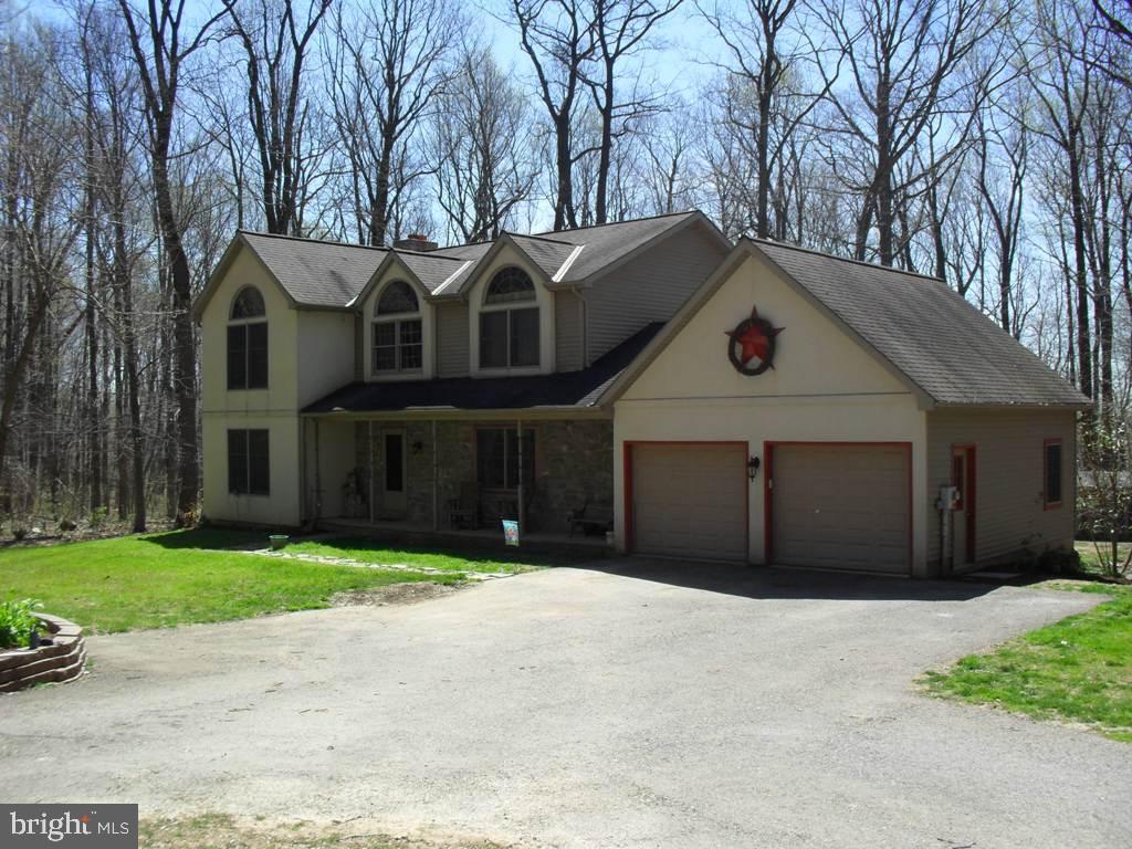 This one owner custom built 4 bedroom Colonial home sets on a 4 acre wooded lot. You will appreciate the craftsmanship throughout the home from the French chandelier greeting you in the foyer to the arch windows for a classy look and feel. The owners attention to detail is evident throughout the home which includes 36'' wide solid wooden doors. The open floor plan from the kitchen to the living room fireplace keeps you right at home!