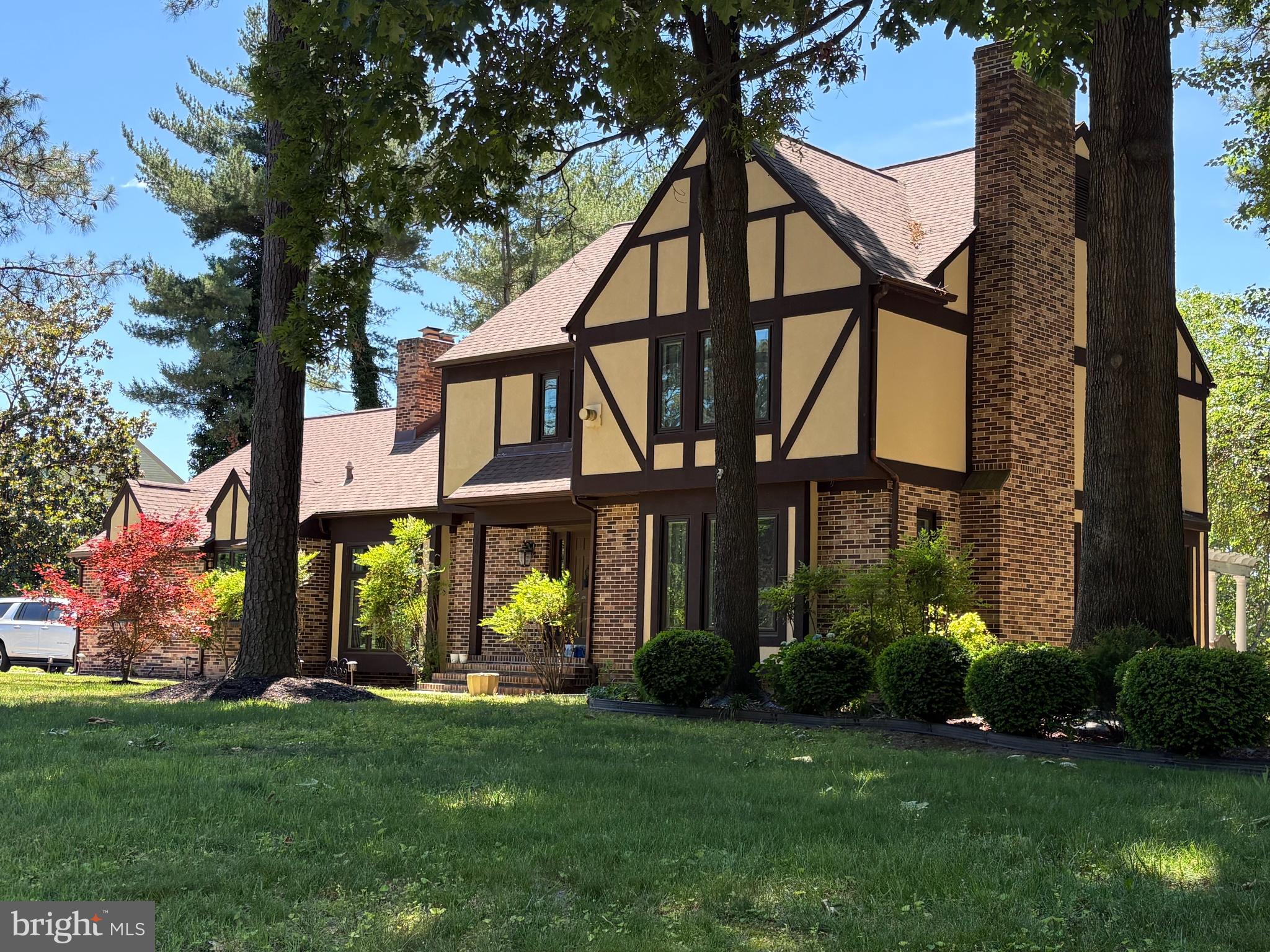 Brimming with updates, this 3875 sq. ft., 4 bedroom, 3.5 bath Nithsdale residence offers a host of inviting spaces for living and entertaining.  While the exterior is a charming Tudor design, the interior is best described as bright and modern. Features include luxury vinyl plank 'wood' and tile flooring throughout the main areas of the 1st floor, a dramatic 2-story foyer with cascading crystal chandelier and an open staircase enhanced by a contemporary metal handrail, three 1st floor fireplaces w/ stone facings, an updated powder room, an updated eat-in kitchen w/ center island and stainless appliances, a stunning family room with soaring 10 ft ceiling, a wall of windows and full view glass doors, as well as ample built-in storage cabinets, a window-filled living room w/ French door entrance, a spacious dining room, 2 rooms that can serve as home offices, and a laundry room w/ washer, dryer, utility sink, and garage access. The 2nd floor offers a primary bedroom with gas fireplace and updated bathroom complete w/ dual sink vanity, soaking tub and walk-in shower, a 2nd bedroom w/ private bath, 2 additional bedrooms, a full hall bath, and a spacious bonus room outfitted as a walk-in closet that any clothes lover would appreciate! The home's exterior provides an inviting patio with overhang  and additional patio space with a pergola to enjoy the warm weather months ahead. Includes a one-year AHS 'Shield Complete' Warranty ($840)