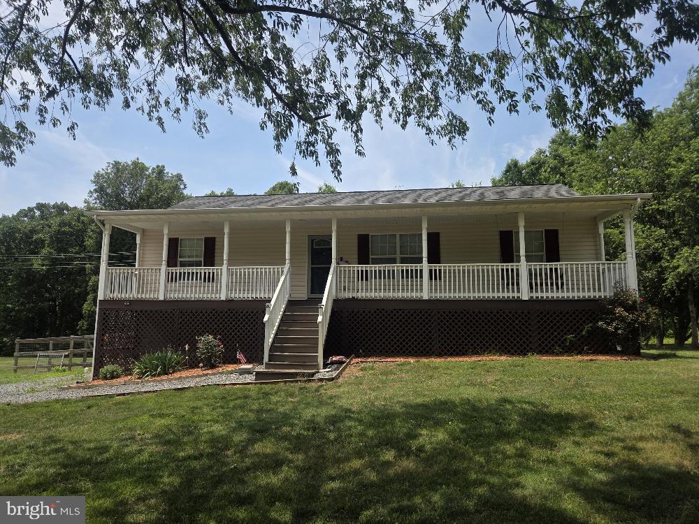 Welcome home to the perfect blend of privacy, comfort, and opportunity! Situated on 3 usable acres with NO HOA, this move-in-ready property offers the peaceful setting you've been searching for while still providing the convenience of high-speed internet.

Enjoy nature from the welcoming full front porch, complete with a swing where you can sip your morning coffee, watch deer wander by, and listen to the birds sing. The property backs to woods, creating a private backdrop, while the fenced backyard offers space for pets, play, gardening, or entertaining.

Inside, the main level features 3 bedrooms and 2 full bathrooms, including a beautifully updated primary suite with a luxurious bathroom showcasing a tiled walk-in shower with rain shower head, bidet, double vanity, and a walk-in closet with custom shelving. The eat-in kitchen offers granite countertops, stainless steel appliances, a walk-in pantry, and space for a dining table. A sliding glass door leads to the spacious deck overlooking the wooded scenery. The living room is anchored by a cozy gas fireplace, creating a warm and inviting gathering space.

The walk-out lower level expands the home's versatility with a 4th bedroom and full bathroom, including a spacious primary-style suite with a huge walk-in closet. In addition to the finished living area, there is substantial unfinished space for storage. Two additional rooms have already been framed and drywalled, offering an incredible opportunity to easily finish them into a home office, craft room, gym, hobby space, or additional storage.

With 2,688 total square feet, including 1,594 finished square feet, this home provides room to grow and customize to fit your needs. Additional features include updated bathrooms, a ground-level walkout basement, large storage areas, a shed, deck, fenced backyard, and a private wooded setting.

If you've been looking for acreage, privacy, and a home with both move-in-ready comfort and future potential, this property is a must-see. Home has a 3 bedroom perc. New sump pump.