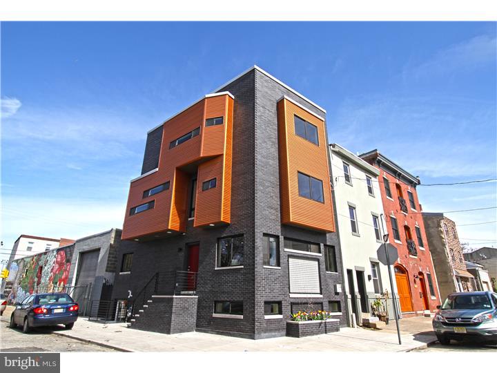 Enjoy this luxury 4 story corner New Construction w/ 10 Year Tax Abatement that offers 3 large bedrooms, 2.5 baths, hardwood & recessed lighting  throughout, multiple outdoor spaces including a roof deck w/ panoramic views & a finished basement built partially above ground level. Curb appeal is vibrant w/ texture including a built-in flower box for plantings plus a "green wall" trellis perfect for flowering vines. Currently we have planted flowering honeysuckle! We love the wide floor plan & over 2,500 sprawling sq ft. of living space. The rare opportunity to be on a corner allows natural light from 3 sides. The 1st floor is raised above street level offering maximum privacy. This main level is expansive w/ an open living room, dining room & kitchen. There is a convenient coat closet & powder room w/ pocket doors tucked away. The kitchen is fitted w/ quartz counter-tops, a waterfall quarts Island w/ under-mount sink, goose neck faucet, dishwasher & ample seating at the bar. The 42" Shaker style cabinetry is perfectly paired w/ a stunning white subway tile back splash, high-end stainless appliances, gas range w/ vent hood, & a lower microwave cabinet. The refrigerator includes a water feature, pull out freezer drawer & French doors. All stairs have custom iron forged railings including those that lead to the finished basement. The basement is partially above terrain giving an above ground feel & more natural light. Floors are beautiful contemporary polished concrete. 2nd floor level has 2 big bedrooms w/ 2 panel wooden doors & custom windows maximizing every view. Guest bedrooms share a hall bath w/ floating vanity,  a soaking tub & shower combination, & custom tile work. There is a laundry closet in the 2nd floor hall as well. The master bedroom 3rd floor is stunning w/ a bonus "flex space" / "nook" that can be a sitting area, a place to feature a beautiful vintage piece of furniture, or whatever your heart desires. The huge closet can be accessed through the en-suite bath or through the bedroom. The master bath has a glass enclosed shower, dual sink, storage vanity  & custom tile. The 3rd floor hall staircase leads to a roof deck pilot house. The roof deck has panoramic views of Philadelphia & Center City. We must mention that this home is extremely air tight due to the use of spray foam insulation throughout which equates to low utility bills for you. An extremely friendly walkable location in Fishtown close to great cafes & restaurants!