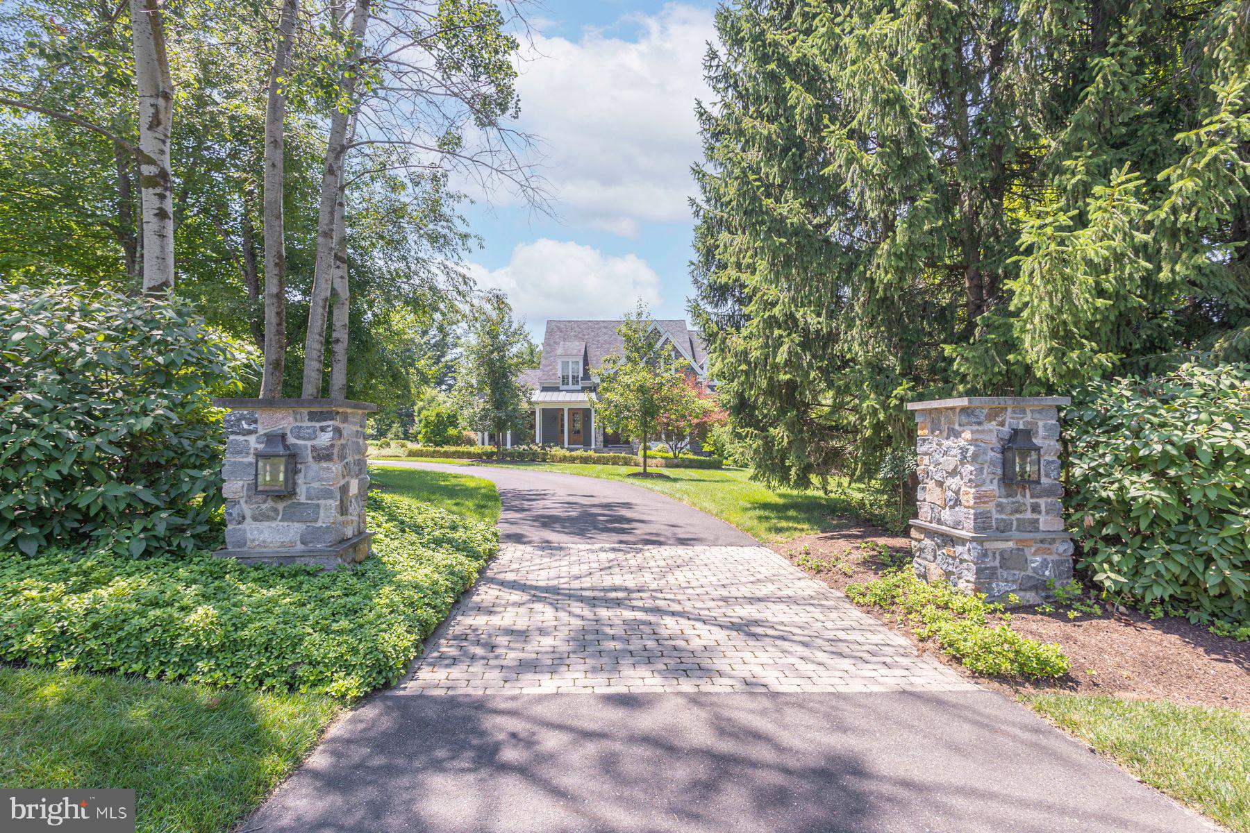 The one you've been waiting for has arrived. Nestled within the highly sought-after Stonymead community in Buckingham Township, this exceptional custom-built residence is the epitome of timeless design, effortless luxury, and impeccable craftsmanship.
Thoughtfully designed for today's lifestyle, the home offers four bedrooms, including a luxurious main-level primary suite, an open, light-filled floor plan, and clean architectural lines that create an atmosphere of understated elegance. Every room reflects meticulous attention to detail, blending sophisticated finishes with warm, inviting spaces that feel both refined and comfortable.
The heart of the home is a stunning chef's kitchen featuring a Wolf range, Sub-Zero refrigeration, a dramatic tiled feature wall, expansive island, sunny morning room, and a convenient kitchen office. The adjoining great room is anchored by a beautiful fireplace, creating an inviting gathering space for everyday living and effortless entertaining. A gracious dining room offers access to the wraparound covered porch, while a handsome main-level office and elegant powder room complete the first floor.
Privately tucked away, the exceptional primary suite offers a peaceful sitting area, two generous walk-in closets, and a spa-inspired bath featuring a soaking tub, dual vanities, and an oversized steam shower designed for a true at-home wellness experience.
The upper level is equally impressive, offering a loft gathering space, an en-suite guest bedroom, and an expansive third bedroom with a sitting area, dedicated study, beautifully appointed bath, and an oversized walk-in closet. An additional unfinished area provides abundant storage or the opportunity to create additional finished living space tailored to your needs.
The daylight walk-out lower level extends the home's exceptional living spaces with a spacious recreation room, custom bar, wine cellar, powder room, a private fourth en-suite bedroom, and a finished bonus room ideal as a home gym, theater, studio, or wellness retreat. French doors lead directly to the bluestone patio and beautifully landscaped grounds.
Magazine-worthy from top to bottom, this move-in-ready home showcases exceptional quality throughout. Walls of windows frame the private setting while seamlessly connecting the stunning interior to extraordinary outdoor living spaces. Spectacular landscaping, extensive hardscaping, and multiple outdoor entertaining areas create a private sanctuary that is every bit as remarkable as the home itself.
Perfectly positioned in one of Buckingham Township's most desirable communities, this is a rare opportunity to own a residence where every detail has been thoughtfully designed and impeccably executed. Simply stunning. Effortlessly elegant. Absolutely unforgettable.